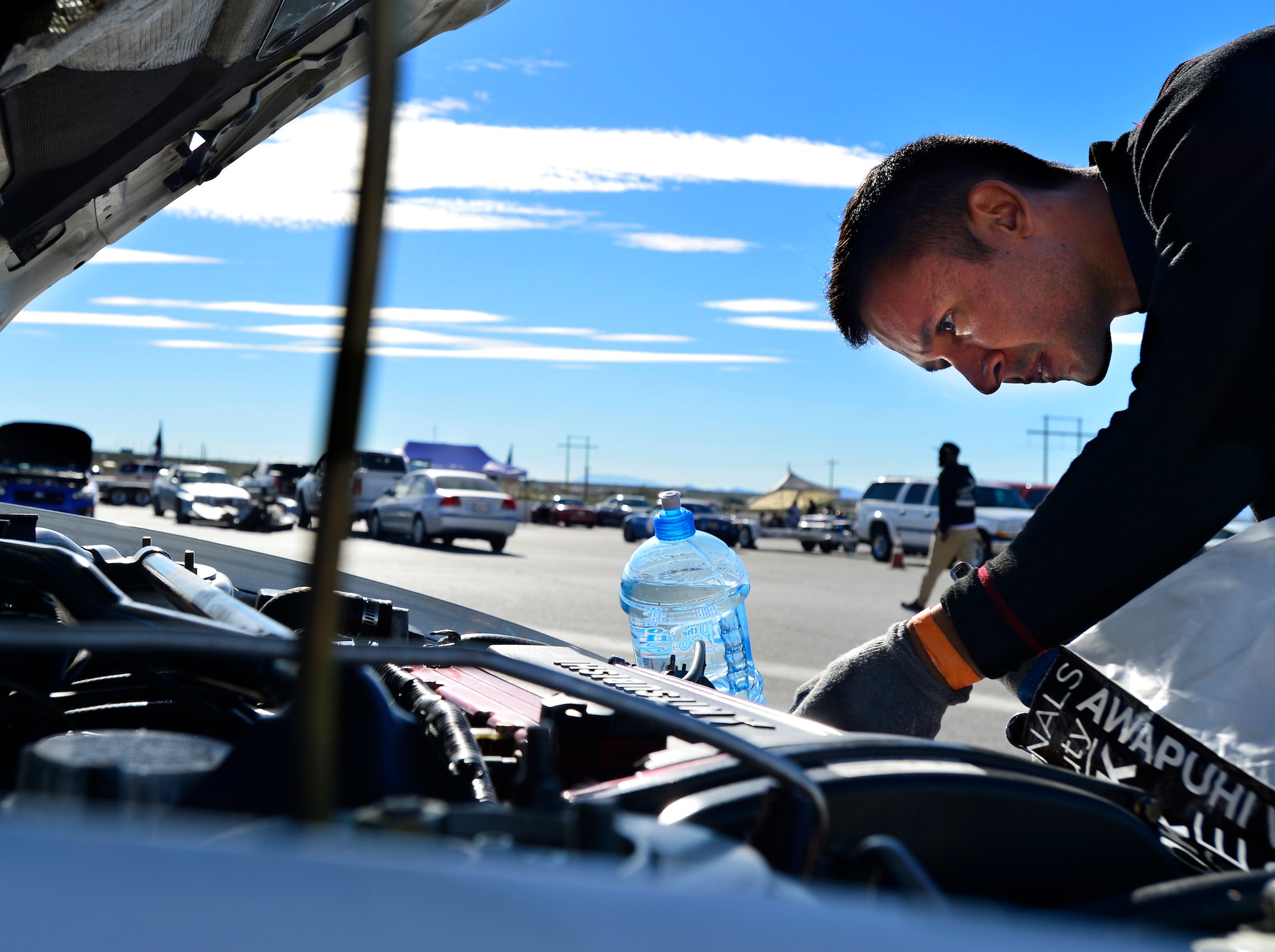 Tech. Sgt. Gabriel, 432nd Wing/432nd Air Expeditionary Wing MQ-9 Reaper sensor operator, inspects his Mitsubishi Lancer Evolution at the Spring Mountain Raceway Nov. 1, 2015, in Pahrump, Nevada. Gabriel has owned and modified his Evolution for over five years. (U.S. Air Force photo by Airman 1st Class Christian Clausen/released)
