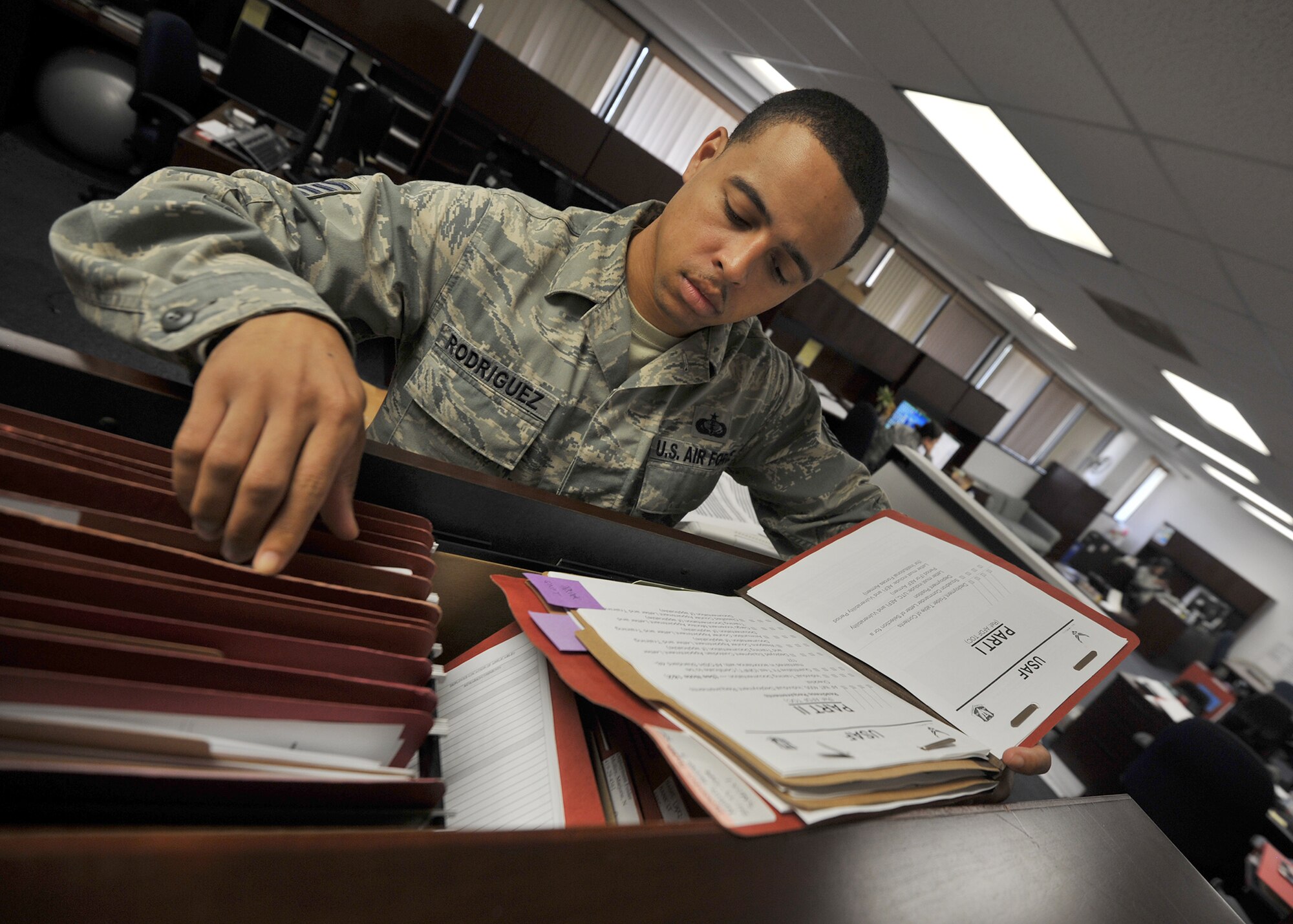 Staff Sgt. Roberto Rodriguez, 325th Force Support Squadron unit deployment manager, sorts and files mobility folders for deploying or likely deploying service members Oct. 28 at the Military Personnel Section building. The overall mission of the Operations Flight is to oversee and manage peacetime as well as wartime contingency planning and execution. Operational planning is a structured process for orderly transition from peace to war and post-hostilities operations. (U.S. Air Force photo by Senior Airman Ty-Rico Lea/Released)