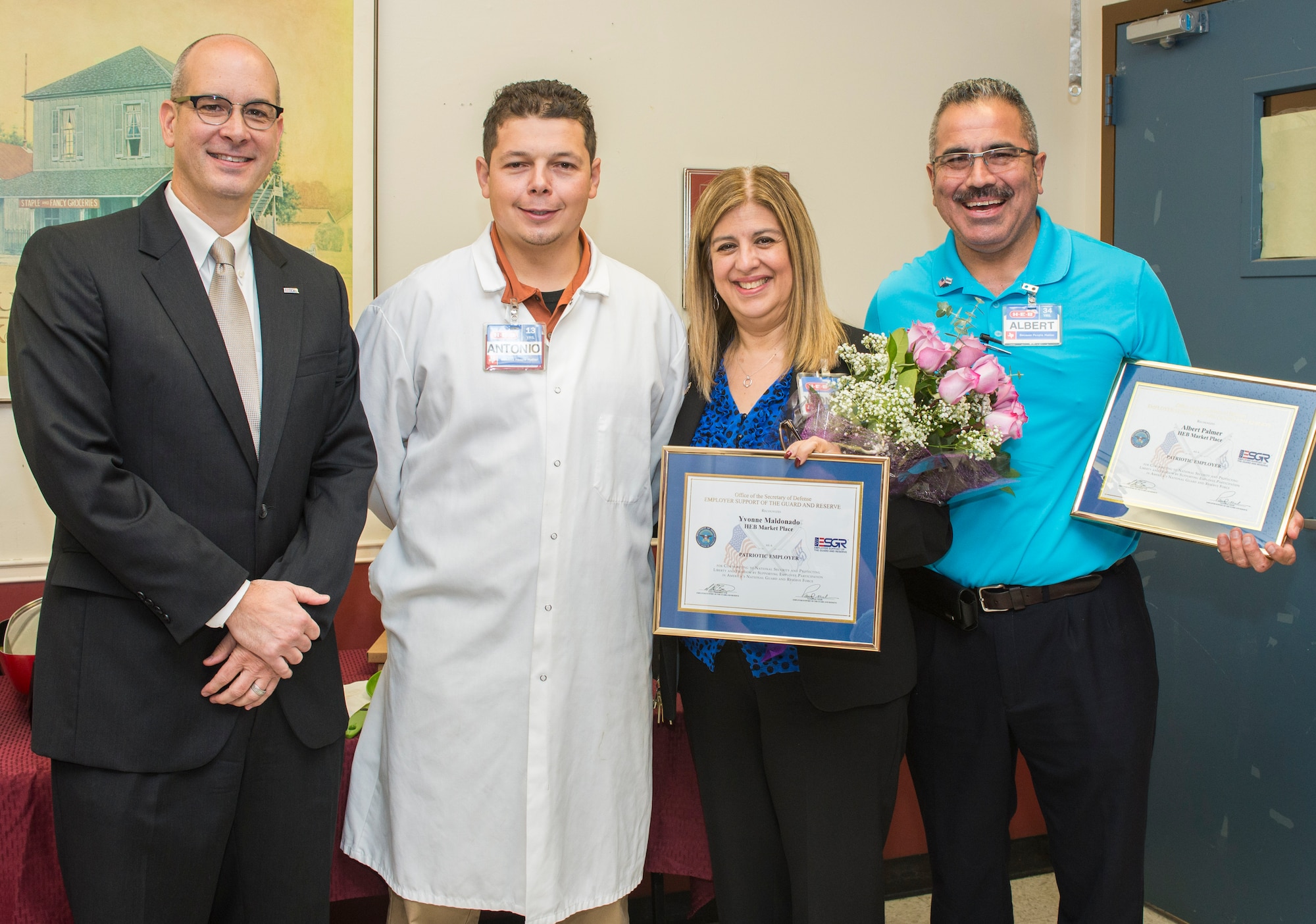 From left, Jeffrey Downing, Employer Support of the Guard and Reserve volunteer, Jose Antonio-Saldivar, H-E-B seafood department manager, Yvonne Maldonado, H-E-B unit director, and Albert Palmer, H-E-B perishable manager, pose for a group photo Nov.4, 2015 at the H-E-B Marketplace in San Antonio, Texas. Maldonado, is a supervisor of a 433rd Airlift Wing member. The ESGR awards employers with the Patriot Award as a way to say thank you for supporting their Reserve and National Guard employees. (U.S. Air Force photo by Benjamin Faske) (released)