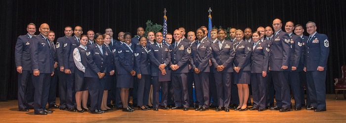 The new graduates of the Community College of the Air Force from the 628th Air Base Wing and the 437th Airlift Wing pose for a photo at the theater on Joint Base Charleston – Air Base, S.C., Nov. 4, 2015. These graduates are from all career fields spanning the entire Joint Base, to include numerous squadrons, ranks and missions. (U.S. Air Force photo/Airman 1st Class Thomas T. Charlton)