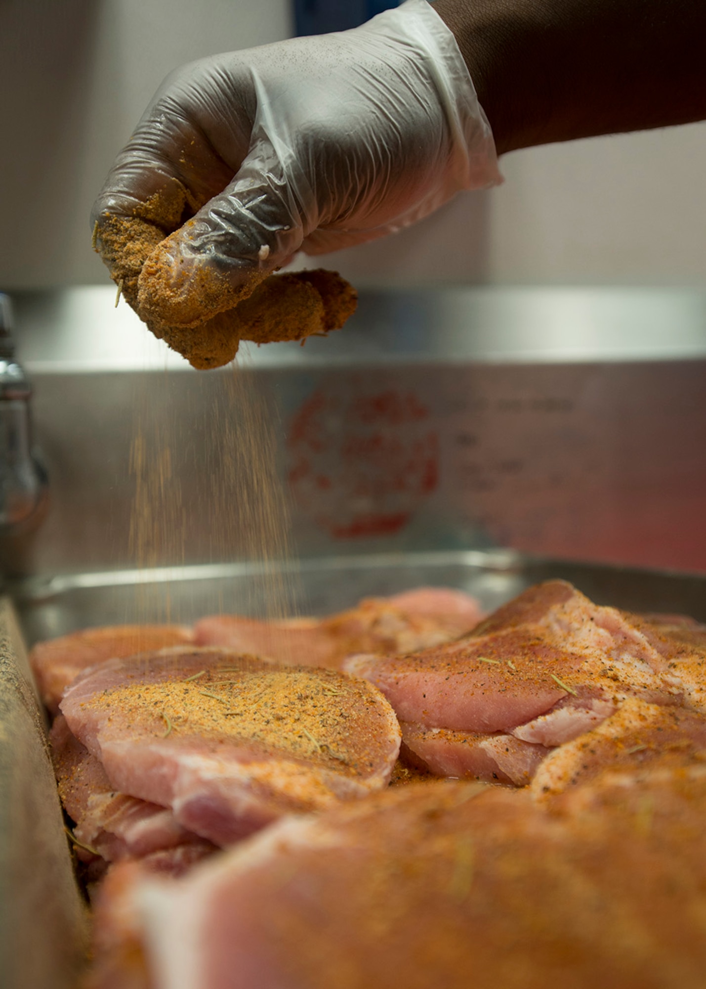 U.S. Air Force Senior Airman Fritz Javel, 633rd Force Support Squadron services journeyman, mixes seasonings and spices in Raptor Café at Langley Air Force Base, Va., Oct. 30, 2015. The flight line kitchen hours of operations are 10 a.m. to 4:30 p.m. daily.  (U.S. Air Force photo by Staff Sgt. John D. Strong II/Released)