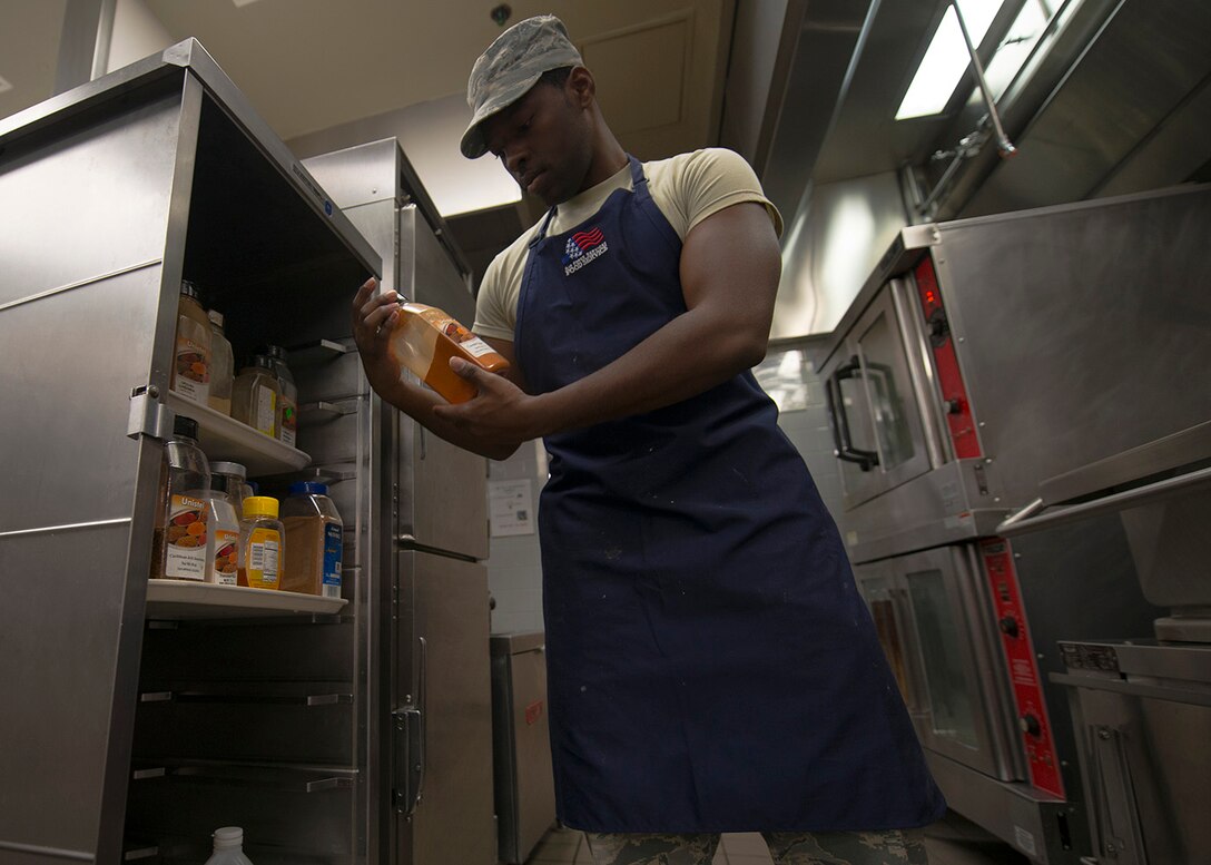 U.S. Air Force Senior Airman Fritz Javel, 633rd Force Support Squadron services journeyman, reads the nutrition facts for ingredients in the Raptor Café at Langley Air Force Base, Va., Oct. 30, 2015. Javel prepared his final meal in the flight line kitchen before transitioning to fitness assessment cell duty. (U.S. Air Force photo by Staff Sgt. John D. Strong II/Released)