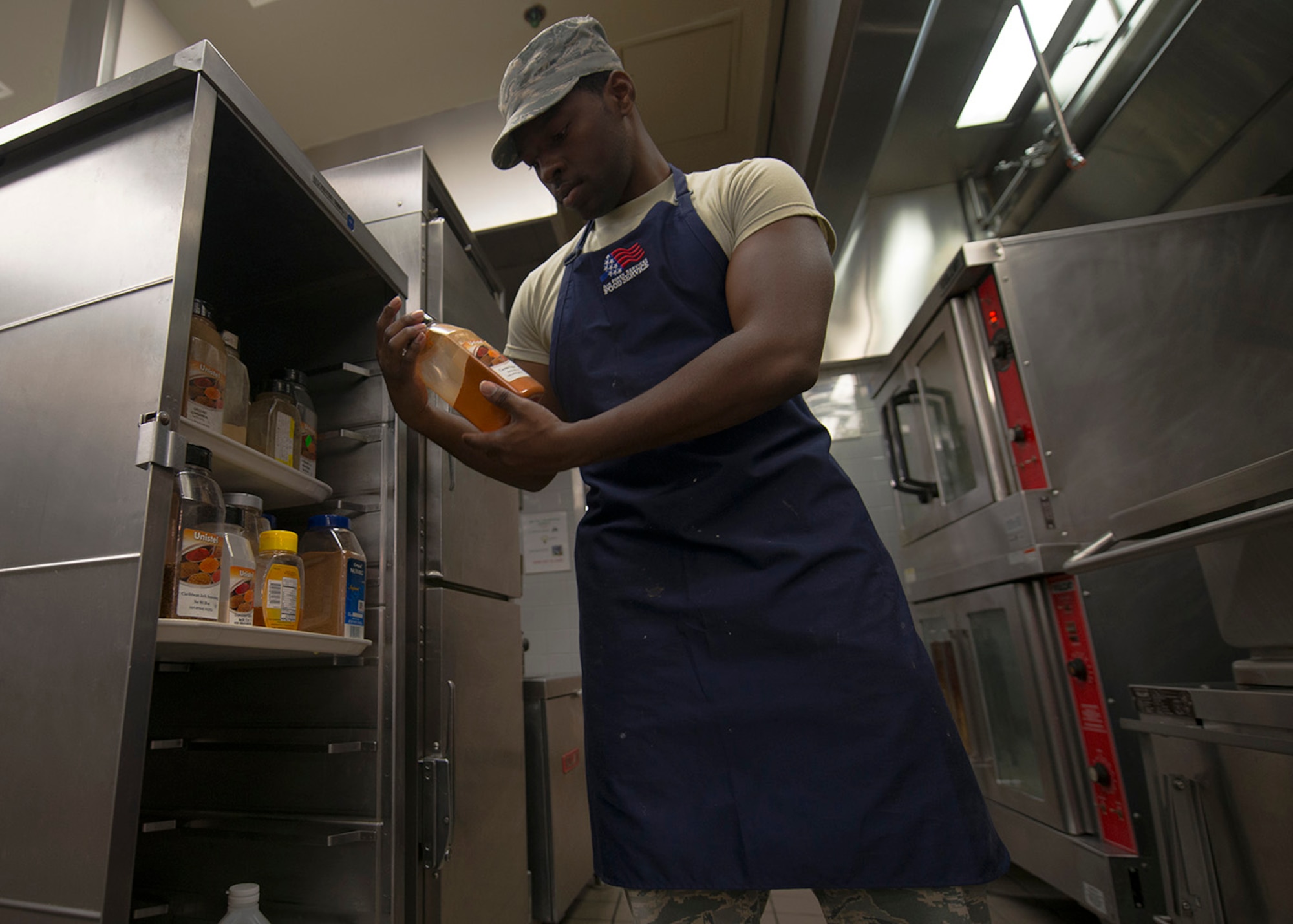U.S. Air Force Senior Airman Fritz Javel, 633rd Force Support Squadron services journeyman, reads the nutrition facts for ingredients in the Raptor Café at Langley Air Force Base, Va., Oct. 30, 2015. Javel prepared his final meal in the flight line kitchen before transitioning to fitness assessment cell duty. (U.S. Air Force photo by Staff Sgt. John D. Strong II/Released)