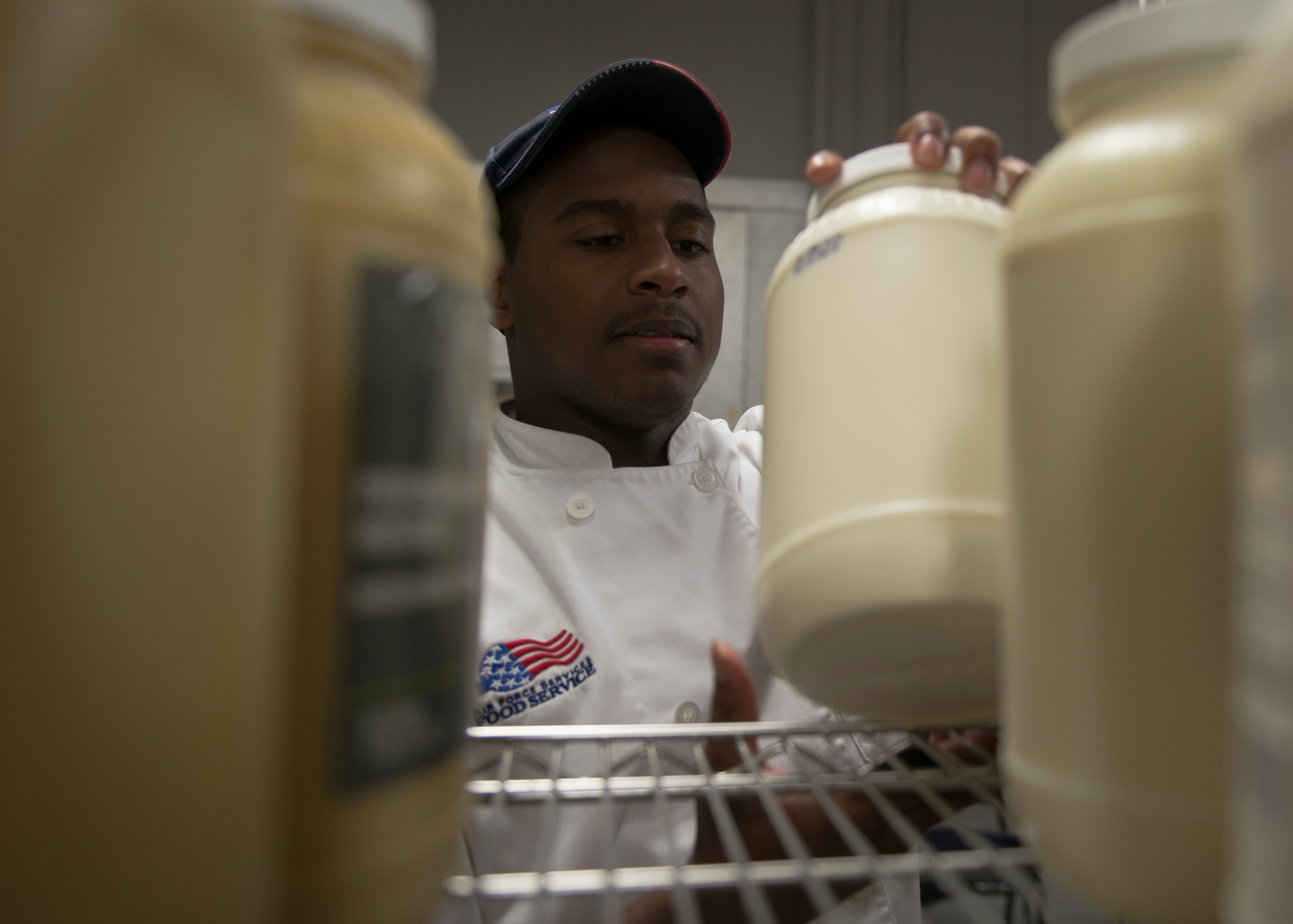 U.S. Air Force Senior Airman Damian Jefferson, 633rd Force Support Squadron services journeyman, inspects a supply room in the Raptor Café at Langley Air Force Base, Va., Oct. 30, 2015. The kitchen chefs prepare 63 different meal combinations during a 21-day span to feed flight line Airmen. (U.S. Air Force photo by Staff Sgt. John D. Strong II/Released)