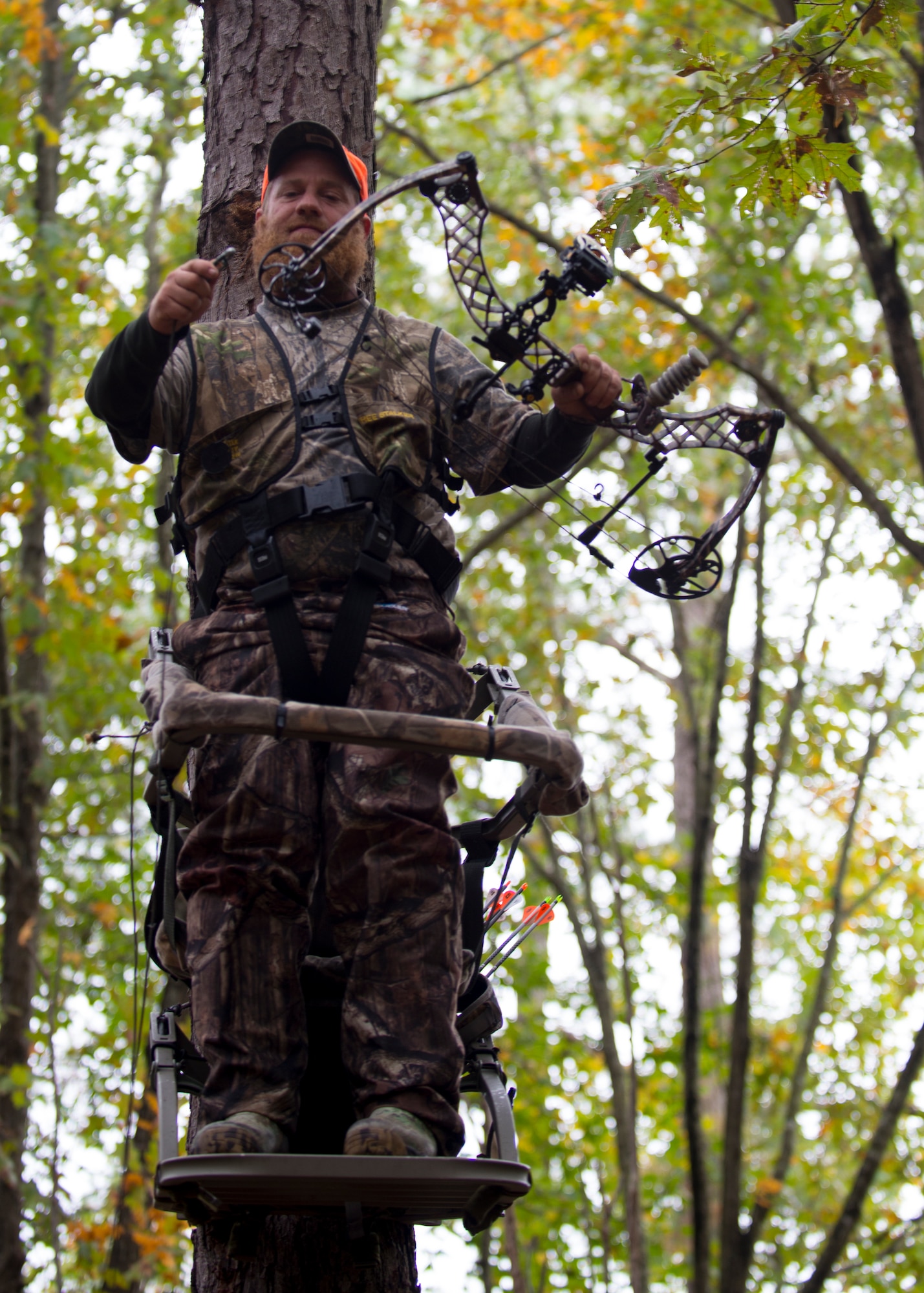 Jeremy Liehr, husband of U.S. Army Sergeant First Class Sharon Liehr, ties a rope line to his bow at the hunting grounds on Fort Eustis, Va., October 28, 2015. A rope line allows Liehr to retrieve and lower his bow safely before and after climbing into a tree stand.(U.S. Air Force photo by Staff Sgt. John D. Strong II) 