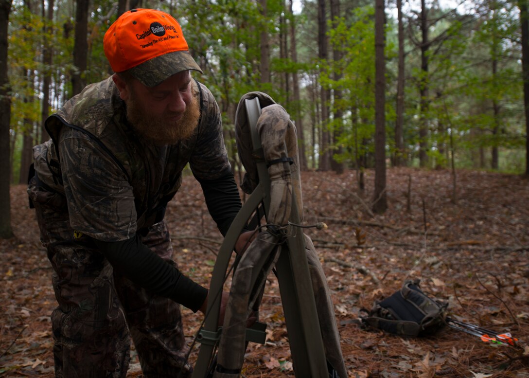 Jeremy Liehr, husband of U.S. Army Sergeant First Class Sharon Liehr, configures his tree stand before hunting at the hunting grounds on Fort Eustis, Va., October 28, 2015. A three point safety harness is mandatory in climbing into a tree stand on the Langley Air Force Base and Fort Eustis hunting grounds. (U.S. Air Force photo by Staff Sgt. John D. Strong II) 