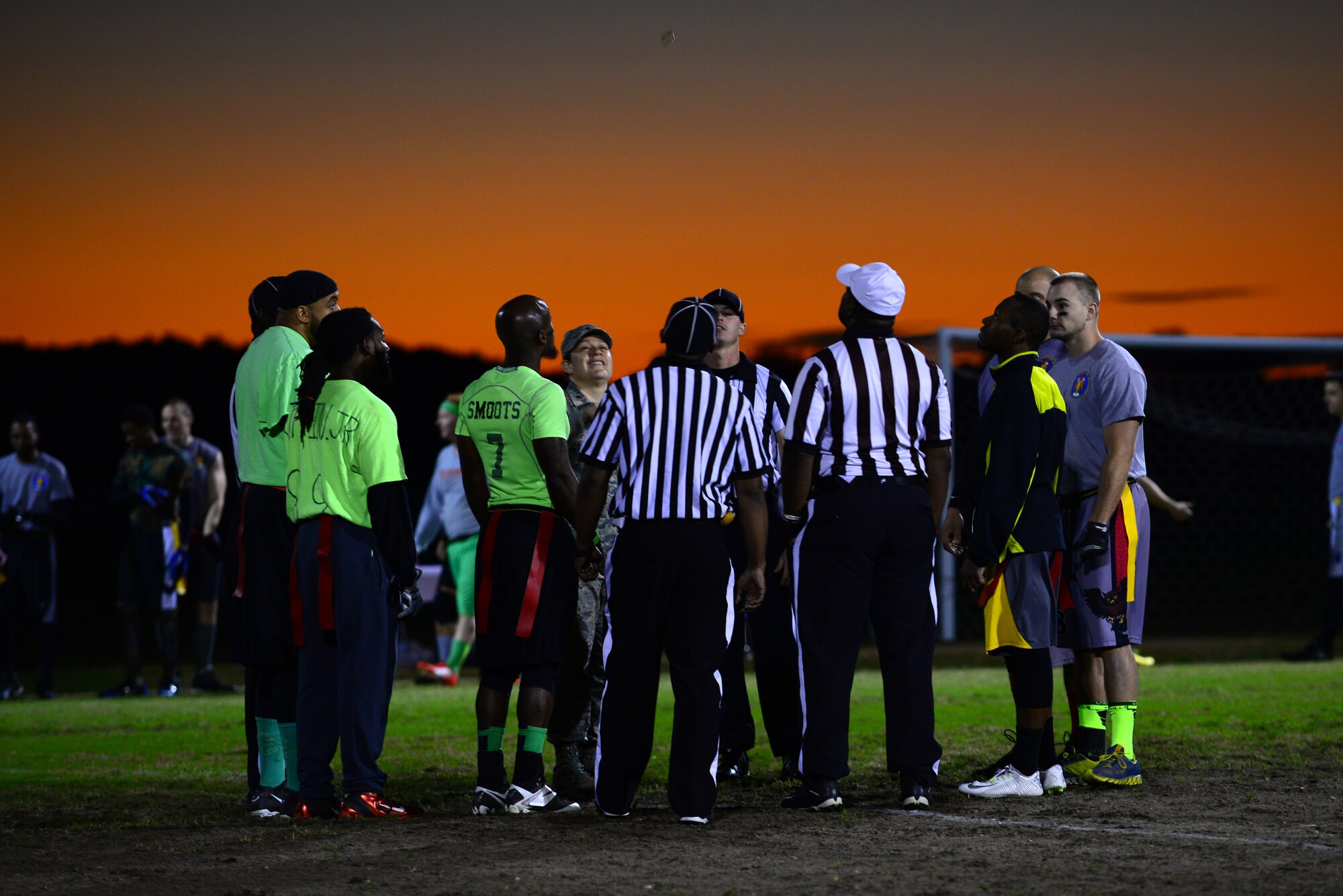 Members of the Ryan Center and the 45th Intelligence Squadron teams await the coin toss prior to the start of the 2015 Intramural Football Championship at Langley Air Force Base, Va., Nov. 3, 2015. The Ryan Center won the toss, choosing to receive the ball at the beginning of the first quarter.  (U.S. Air Force Senior Airman Kimberly Nagle/Released)   