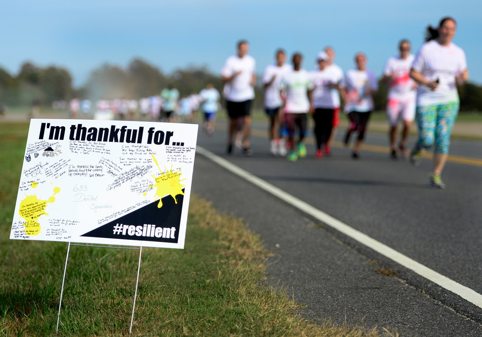 Runners participate in the Joint Base Langley-Eustis Resiliency 5K Color Run at Langley Air Force Base, Va., Oct. 29, 2015. Various units across Langley wrote what they are thankful for on signs posted throughout the running trail. (U.S. Air Force photo by Senior Airman Kayla Newman/Released)