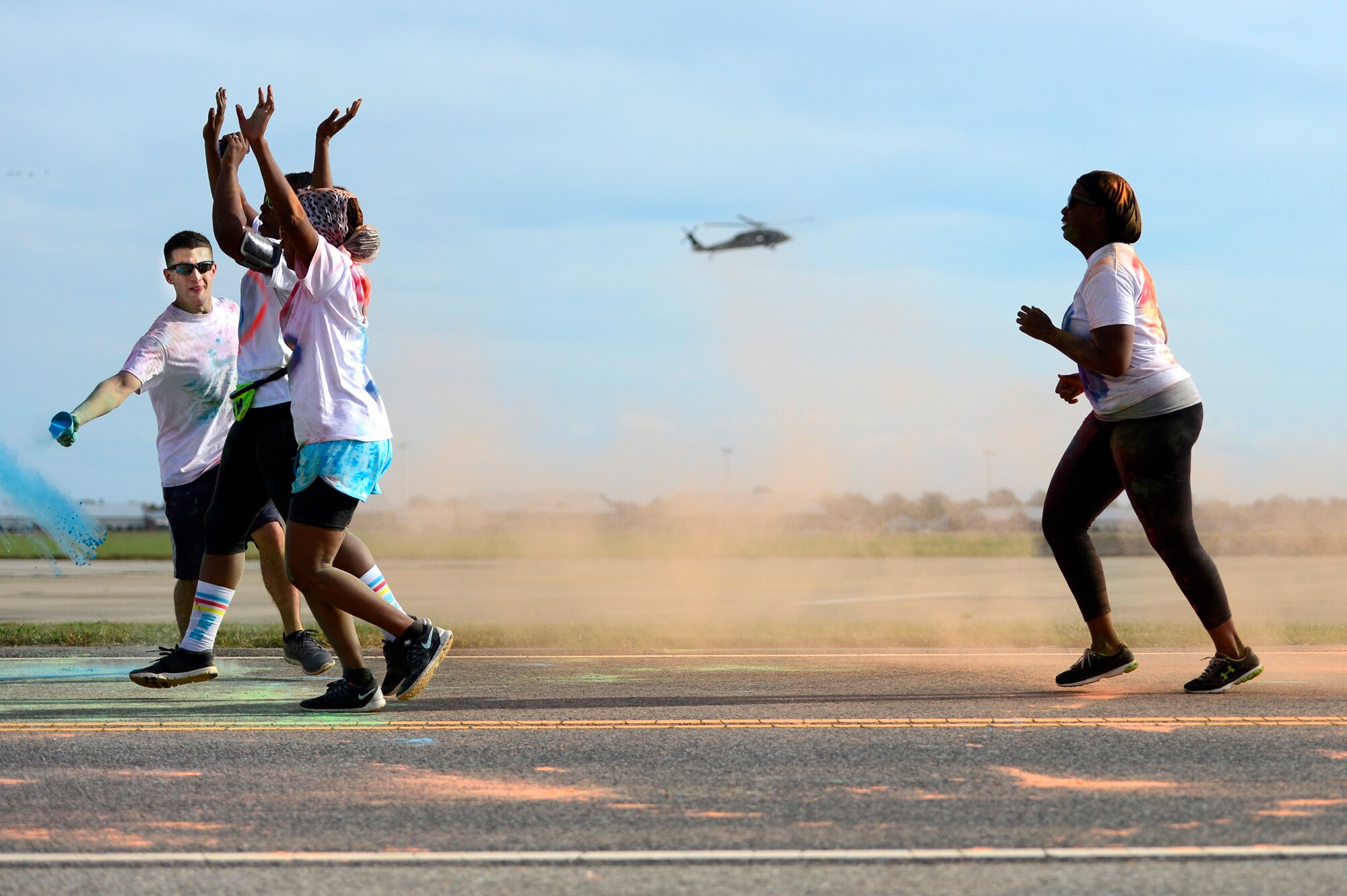 Runners pass through a color station during the Joint Base Langley-Eustis Resiliency 5K Color Run at Langley Air Force Base, Va., Oct. 29, 2015. The run aimed to promote the Comprehensive Airman Fitness pillars and stressed the importance of resiliency.  (U.S. Air Force photo by Senior Airman Kayla Newman/Released)