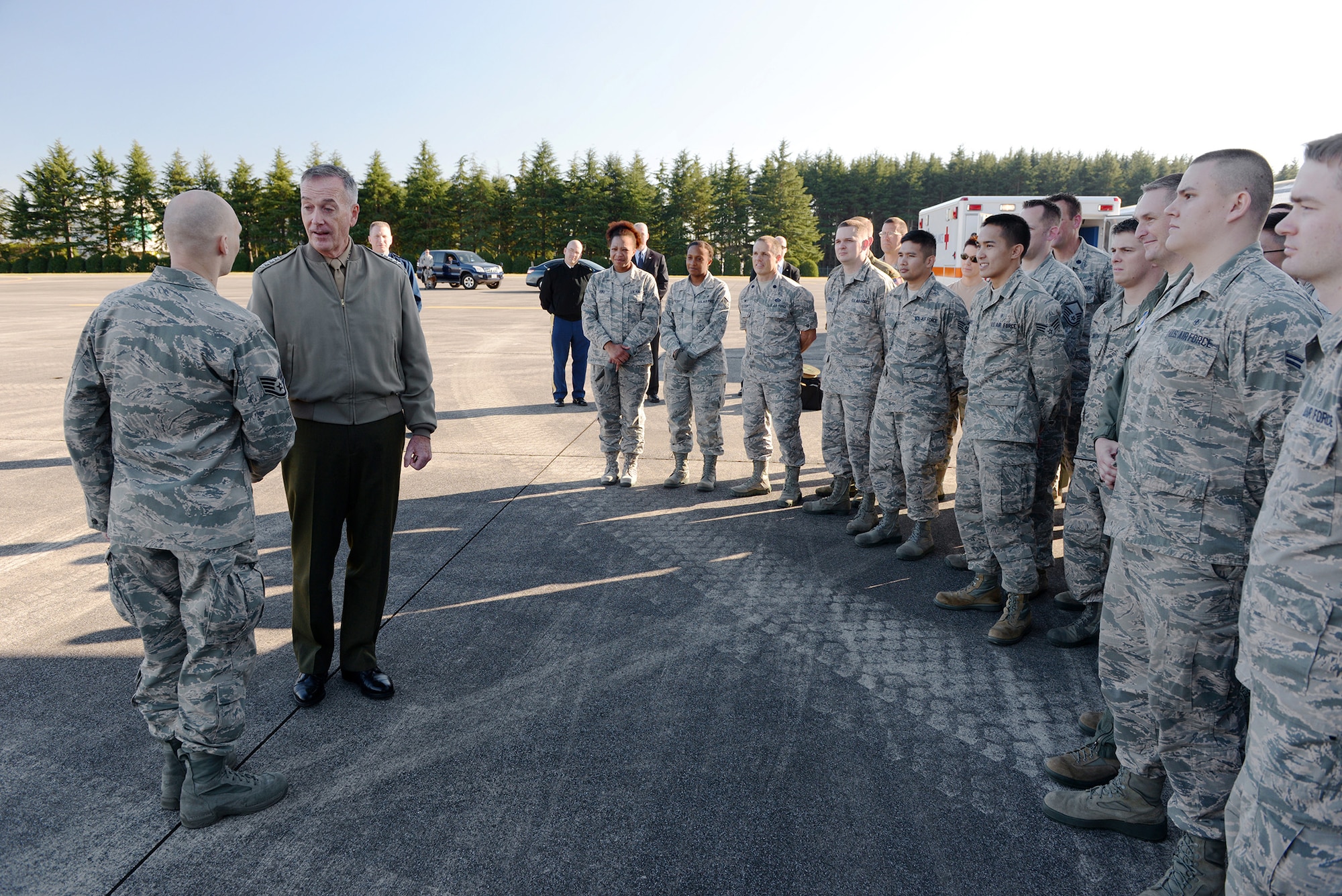Marine Corps Gen. Joseph F. Dunford, the chairman of the Joint Chiefs of Staff,
recognizes an Airmen, coining him for his dedicated work, at Yokota Air Base, Japan,
Nov. 4, 2015. Dunford took time to talk with Yokota Airmen, who were participating in
aeromedical evacuation training, reminding them of the importance of readiness and
training. (U.S. Air Force photo by Staff Sgt. Cody H. Ramirez/Released)