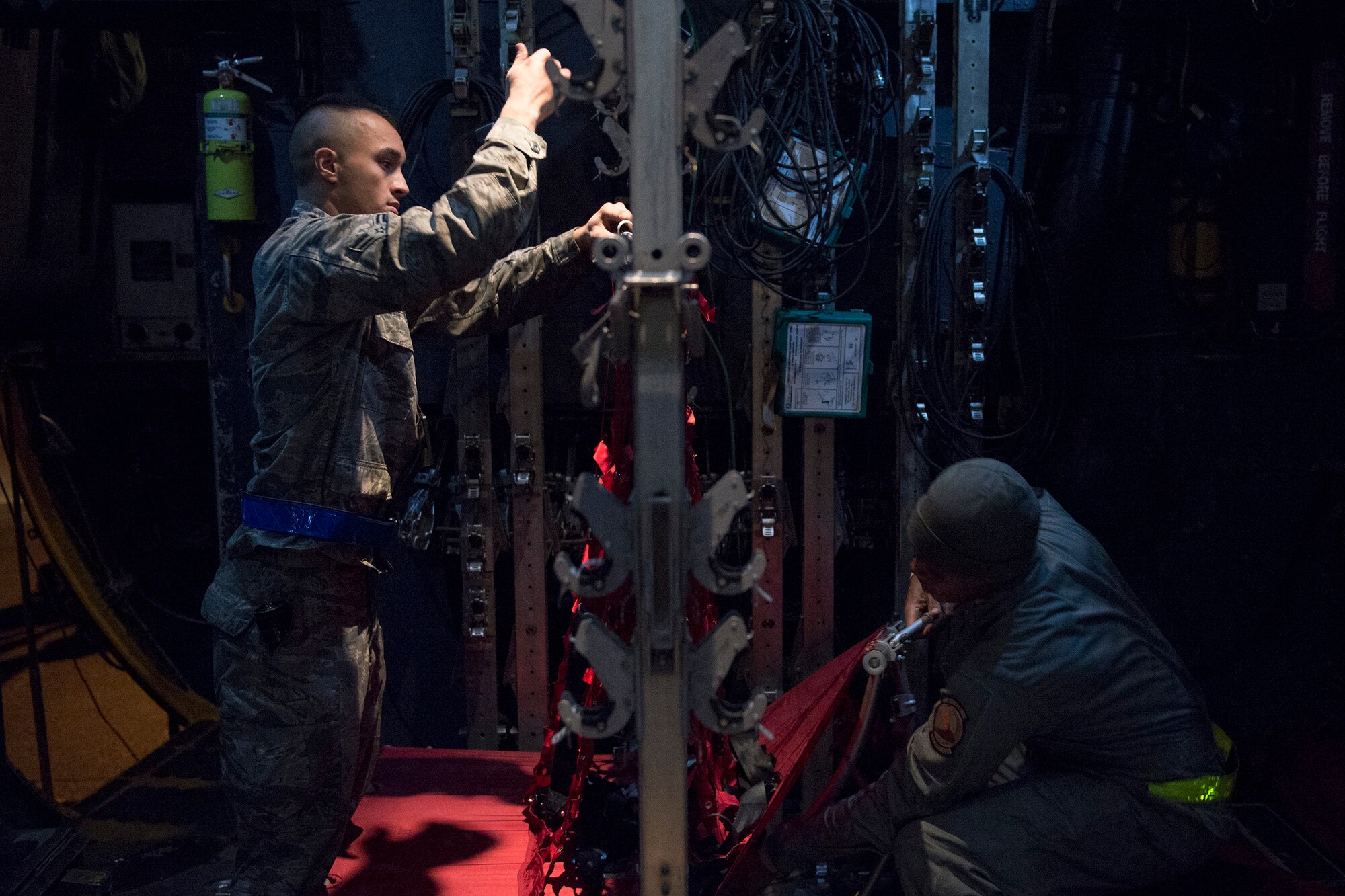 Airmen prepare seating in a C-130 Hercules during VIGILANT ACE 16 at Yokota Air Base, Japan, Nov. 2, 2015. Multiple C-130s were inspected, reconfigured and fueled in preparation of flights for VIGILANT ACE 16, a U.S.-Republic of Korea combined exercise aimed at enhancing operational and tactical level coordination through combined and joint combat training. The exercise also provides critical training for the Airmen of the 374th Airlift Wing to maintain peace and stability in Japan and the entire Indo-Asia Pacific region.  (U.S. Air Force photo by Staff Sgt. Cody H. Ramirez/Released)