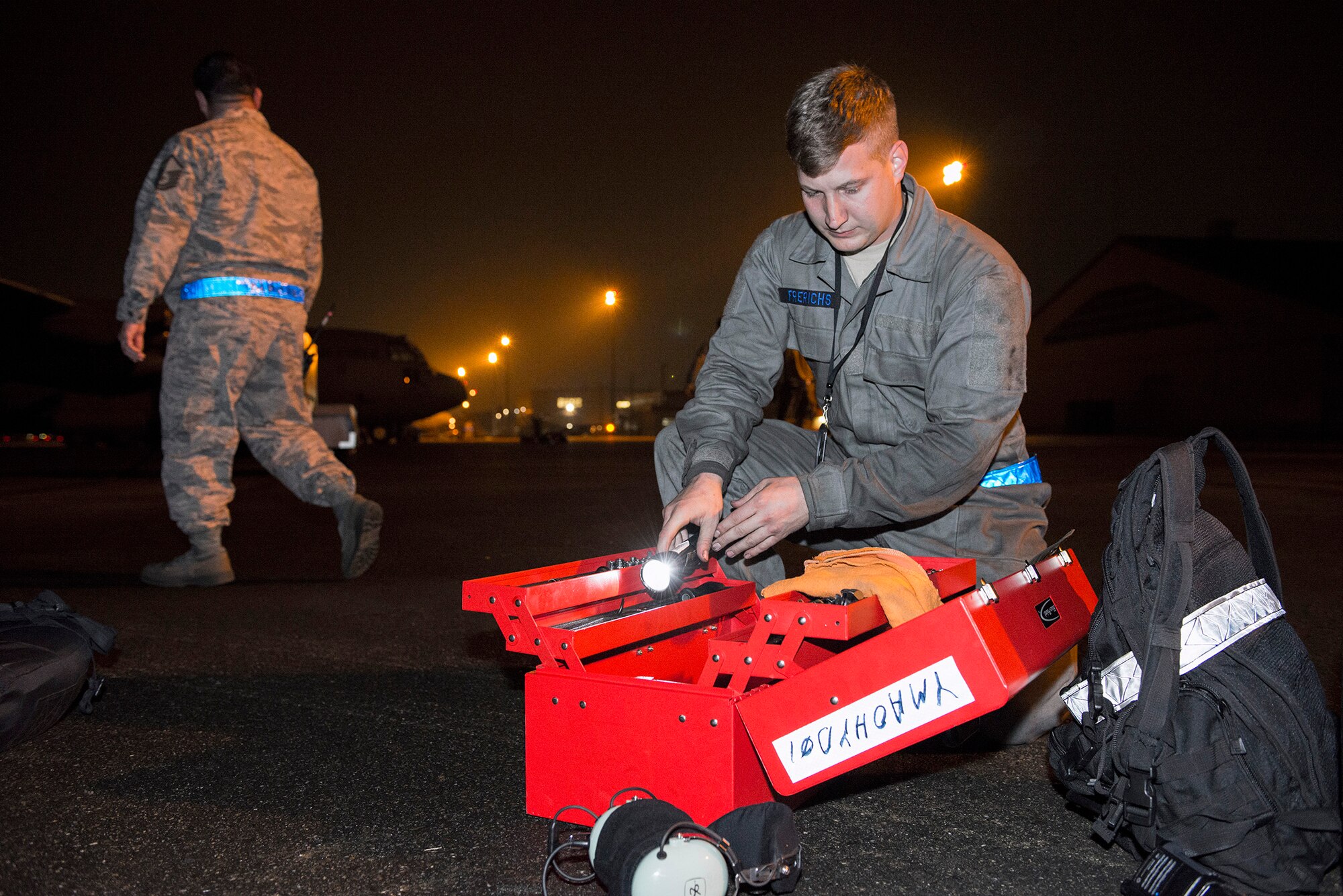 Airman 1st Class John Frerichs, 374th Aircraft Maintenance Squadron hydraulics system technician, searches for tools for a scheduled C-130 Hercules inspection during VIGILANT ACE 16 at Yokota Air Base, Japan, Nov. 2, 2015. Maintainers with the 374 AMXS always work 24 hours a day, 7 days a week, to ensure their C-130 fleet is ready to respond at a moment’s notice for any requirement in the Indo-Asia Pacific region. The exercise tested this readiness and Yokota's ability to receive and deploy forces throughout the theater. (U.S. Air Force photo by Staff Sgt. Cody H. Ramirez/Released)