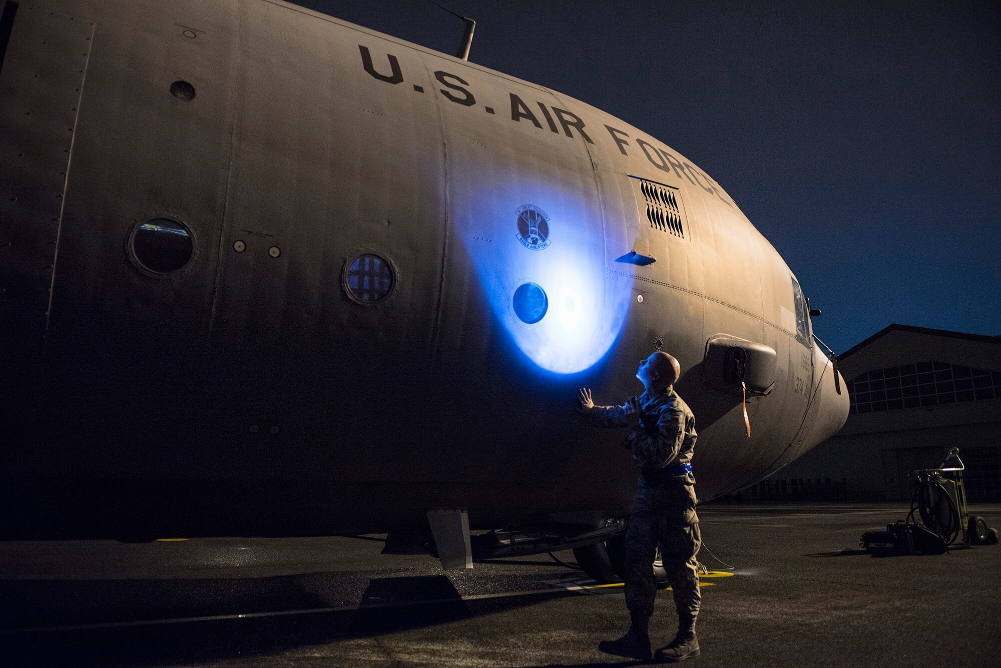 Airman 1st Class Christopher Cook, 374th Aircraft Maintenance Squadron crew chief, inspects a C-130 Hercules for obvious physical damage or leaks and ensures all fasteners are sealed during VIGILANT ACE 16 at Yokota Air Base, Japan, Nov. 2 2015. VIGILANT ACE 16 is a U.S.-Republic of Korea combined exercise aimed at enhancing operational and tactical level coordination through combined and joint combat training. The exercise also provides critical training for the Airmen of the 374th Airlift Wing to maintain peace and stability in Japan and the entire Indo-Asia Pacific region. (U.S. Air Force photo by Staff Sgt. Cody H. Ramirez/Released)
