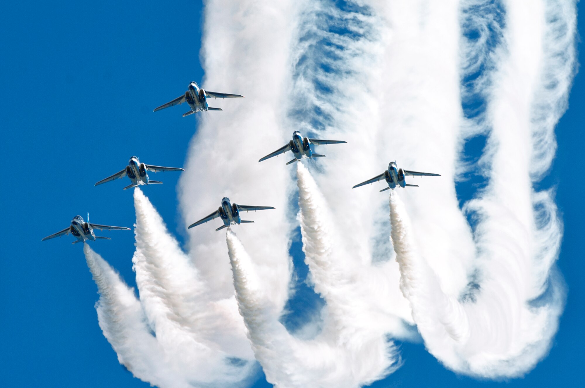 The Japan Air Self-Defense Force aerobatic team, Blue Impulse, fly in formation over Iruma Air Base, Japan, Nov. 3, 2015. Blue Impulse used the smoke-trails to sketch artistic patterns in the sky. (U.S. Air Force photo by Airman 1st Class Delano Scott/Released)