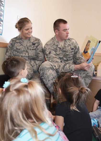 120th Airlift Wing Airmen Staff Sgt. Ashlee Wajer and Airman 1st Class Devon Kennedy volunteer to read a children’s book to students in a daycare in Great Falls, Mont., Oct. 22, 2015. (U.S. Air National Guard photo by Senior Master Sgt. Eric Peterson/Released)