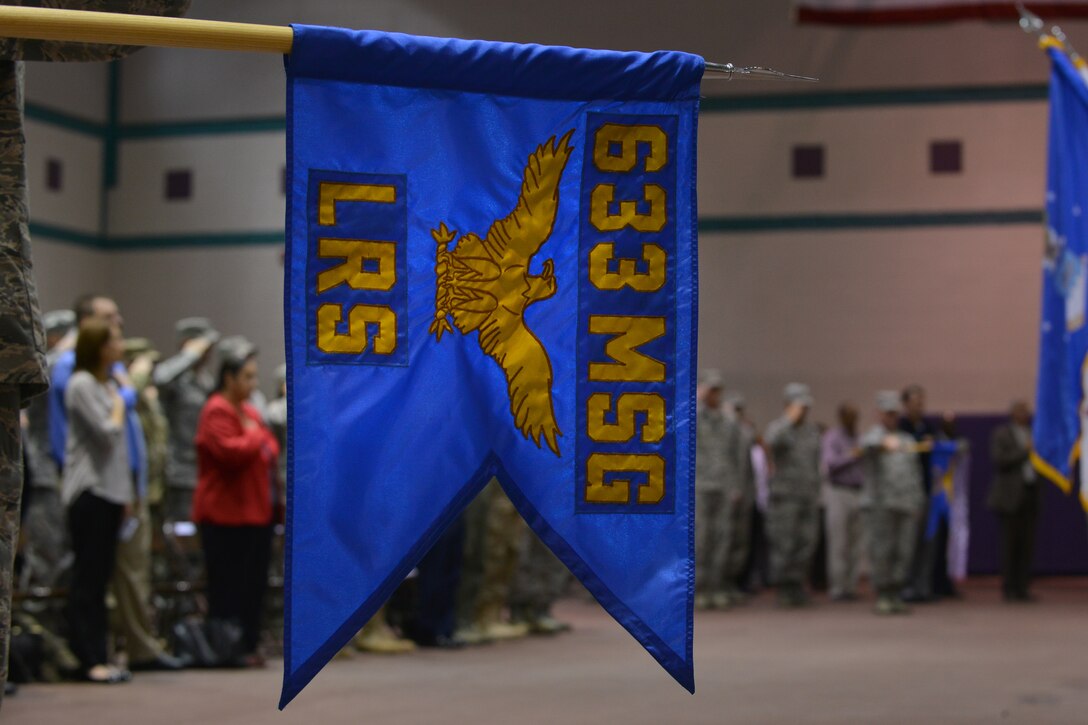 The 633rd Logistics Readiness Squadron guide-on is held at attention for the last time during a merger, activation and deactivation ceremony at Fort Eustis, Va., Nov. 2, 2015. During the ceremony, the 633rd LRS deactivated and its personnel merged into the newly activated 733rd LRS. (U.S. Air Force photo by Staff Sgt. Natasha Stannard/Released)
