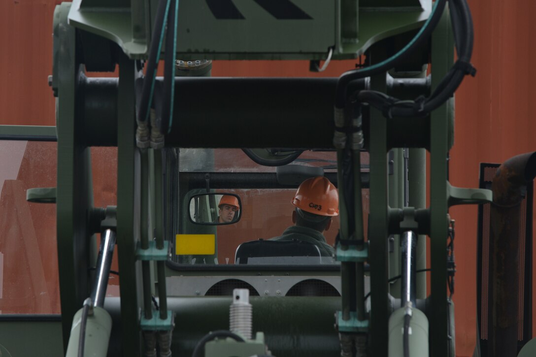 U.S. Army Spc. Josh Rafike, Maritime and Intermodal Training School student, operates a rough terrain container at Fort Eustis, Va., Oct. 28, 2015. During the terrain container handler course, students learn to stack and unstack cargo using the container handlers safely and efficiently. (U.S. Air Force photo by Staff Sgt. Natasha Stannard/ Released)