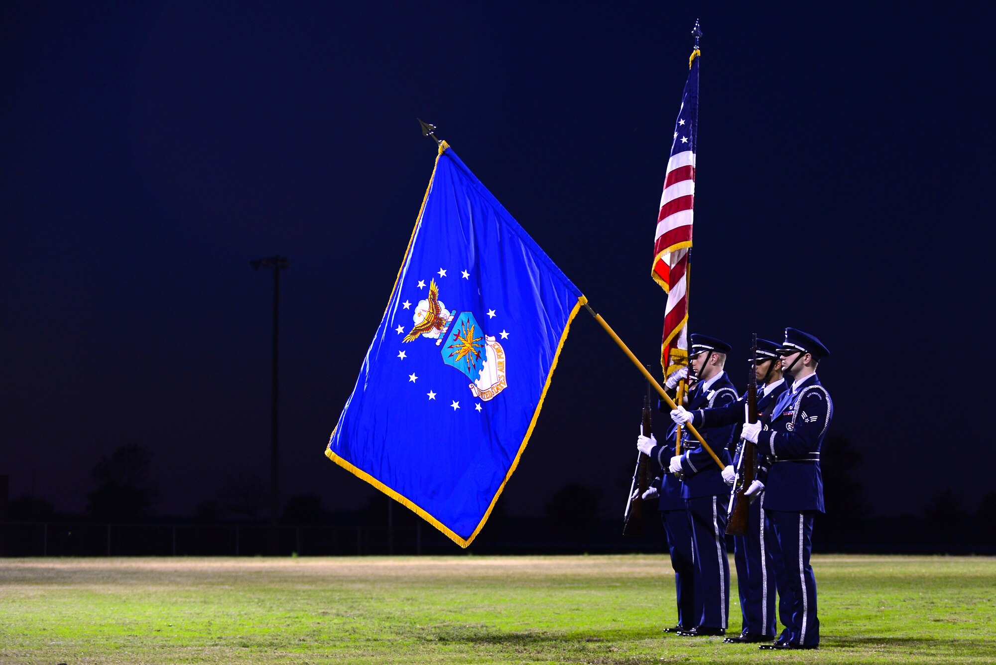 U.S. Air Force Langley Honor Guard Airmen present the colors prior to the 2015 Intramural Football Championship at Langley Air Force Base, Va., Nov. 3, 2015. After 19 teams competed for more than three months in weekly intramural games, the 45th Intelligence Squadron and Ryan Center teams faced off in the championship game. (U.S. Air Force Senior Airman Kimberly Nagle/Released)   