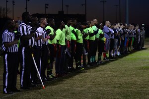 U.S. Air Force Airmen and civilians stand as the national anthem plays prior to the 2015 Intramural Football Championship at Langley Air Force Base, Va., Nov. 3, 2015. The Ryan Center team triumphed against and 45th Intelligence Squadron, with a final score of 20 to 19. (U.S. Air Force photo by Senior Airman Kimberly Nagle/Released) 