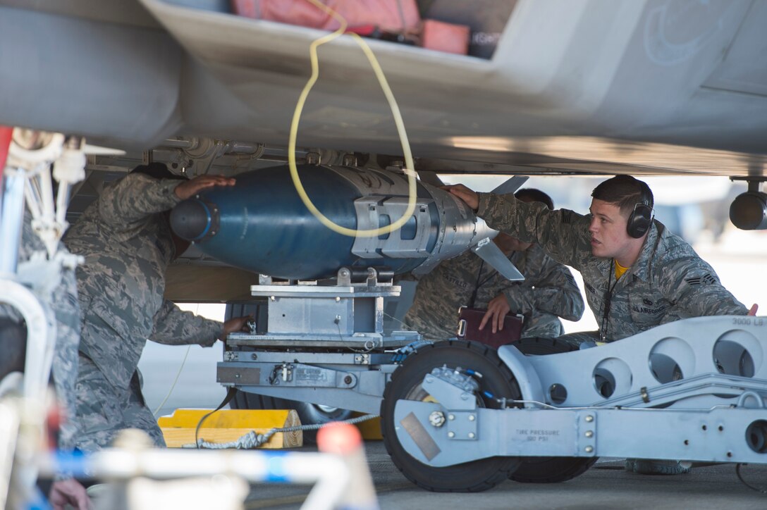 U.S. Air Force Airmen assigned to the 27th Fighter Squadron load a GBU-32 into an F-22 Raptor during a weapons load competition at Langley Air Force Base, Va., Oct. 30, 2015. The competition was held to recognize the outstanding load crew for all of the 1st Maintenance Group. (U.S. Air Force photo by Senior Airman Kayla Newman/Released)
