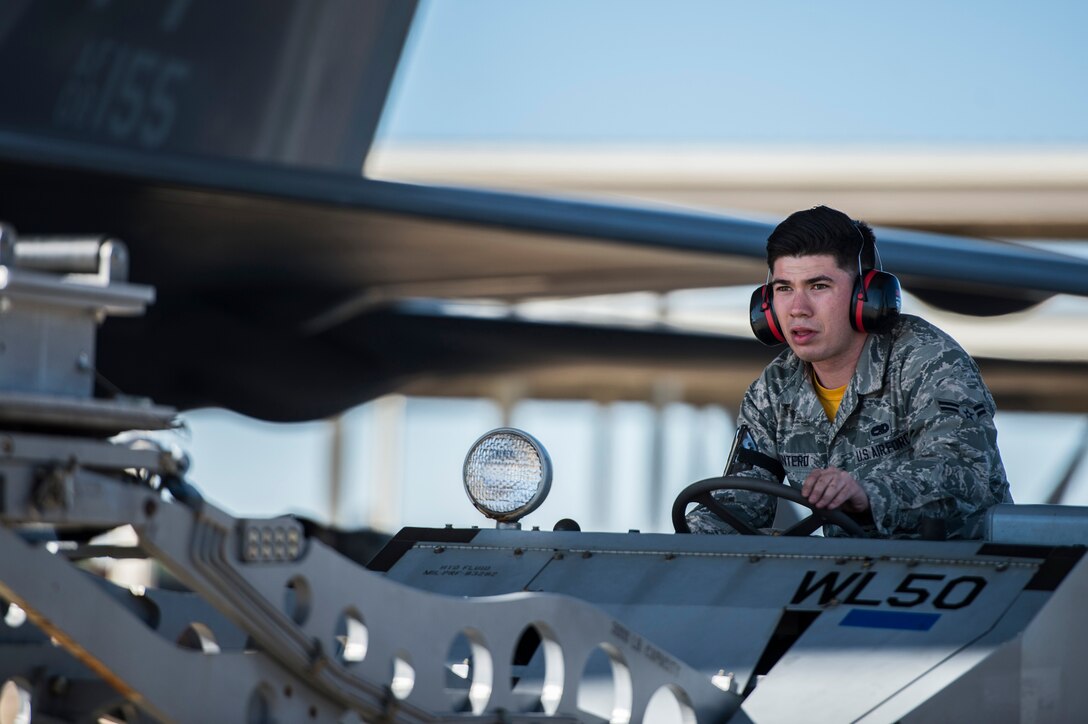 U.S. Air Force Airman 1st Class Andrew Quintero, 27th Fighter Squadron load crew member, operates a MJ-1 lift truck during a weapons load competition at Langley Air Force Base, Va., Oct. 30, 2015. The lift truck was used to load GBU-32s into an F-22 Raptor. (U.S. Air Force photo by Senior Airman Kayla Newman/Released)