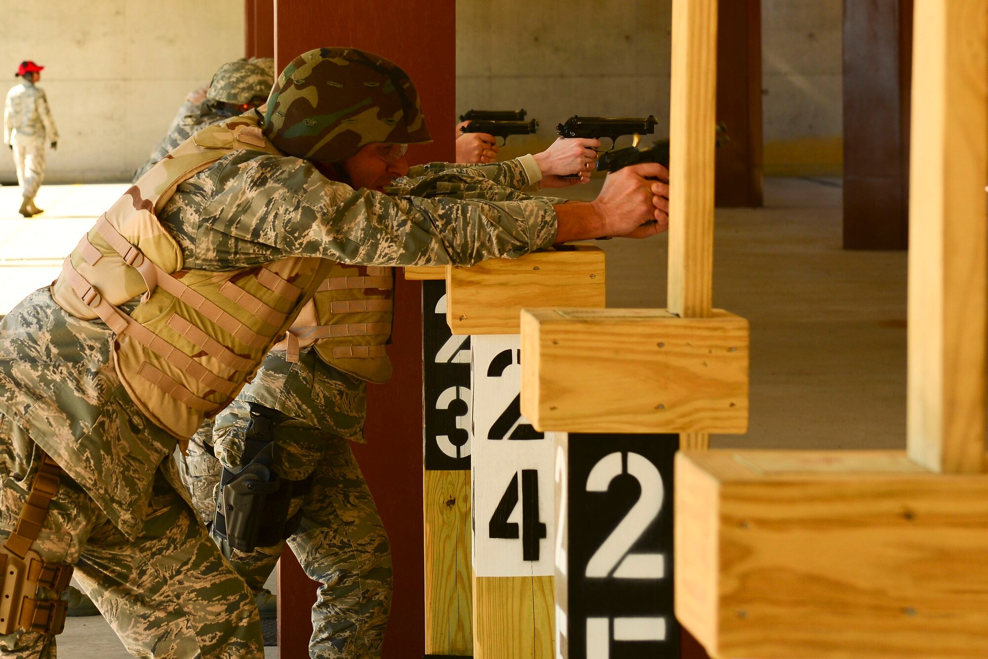 U.S. Air Force Lt. Col. Mo Calabrese, Air Combat Command branch chief, fires a Berretta M9 pistol at the Combat Arms Training and Maintenance range at Langley Air Force Base, Va., Oct. 30, 2015. Calabrese tested on several different components, positions and distances to become qualified with the M9 pistol. (U.S. Air Force photo by Airman 1st Class Derek Seifert/ Released)