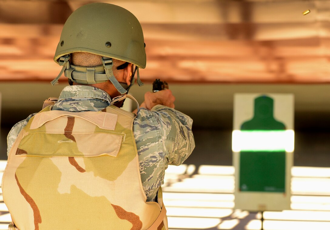 A U.S. Air Force Airman fires a Berretta M9 pistol at the Combat Arms Training and Maintenance range at Langley Air Force Base, Va., Oct. 30, 2015. To qualify with the M9, Airmen must hit targets at seven, 15 and 25 meters away. (U.S. Air Force photo by Airman 1st Class Derek Seifert/ Released)