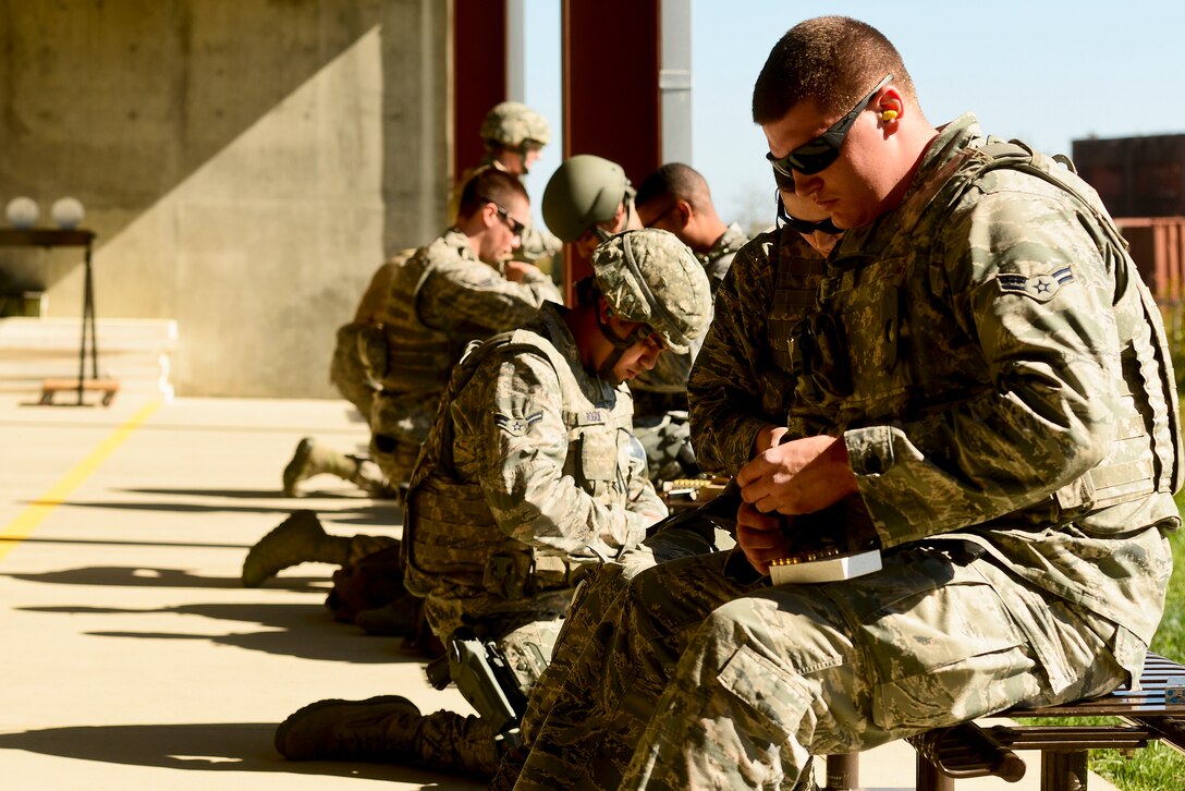 U.S. Air Force Airmen load magazines with 9 mm rounds before qualifying at the Combat Arms Training and Maintenance range at Langley Air Force Base, Va., Oct. 30, 2015. Airmen attended a two-hour classroom session to become familiar with the Berretta M9 pistol prior to the firing portion. (U.S. Air Force photo by Airman 1st Class Derek Seifert/ Released)