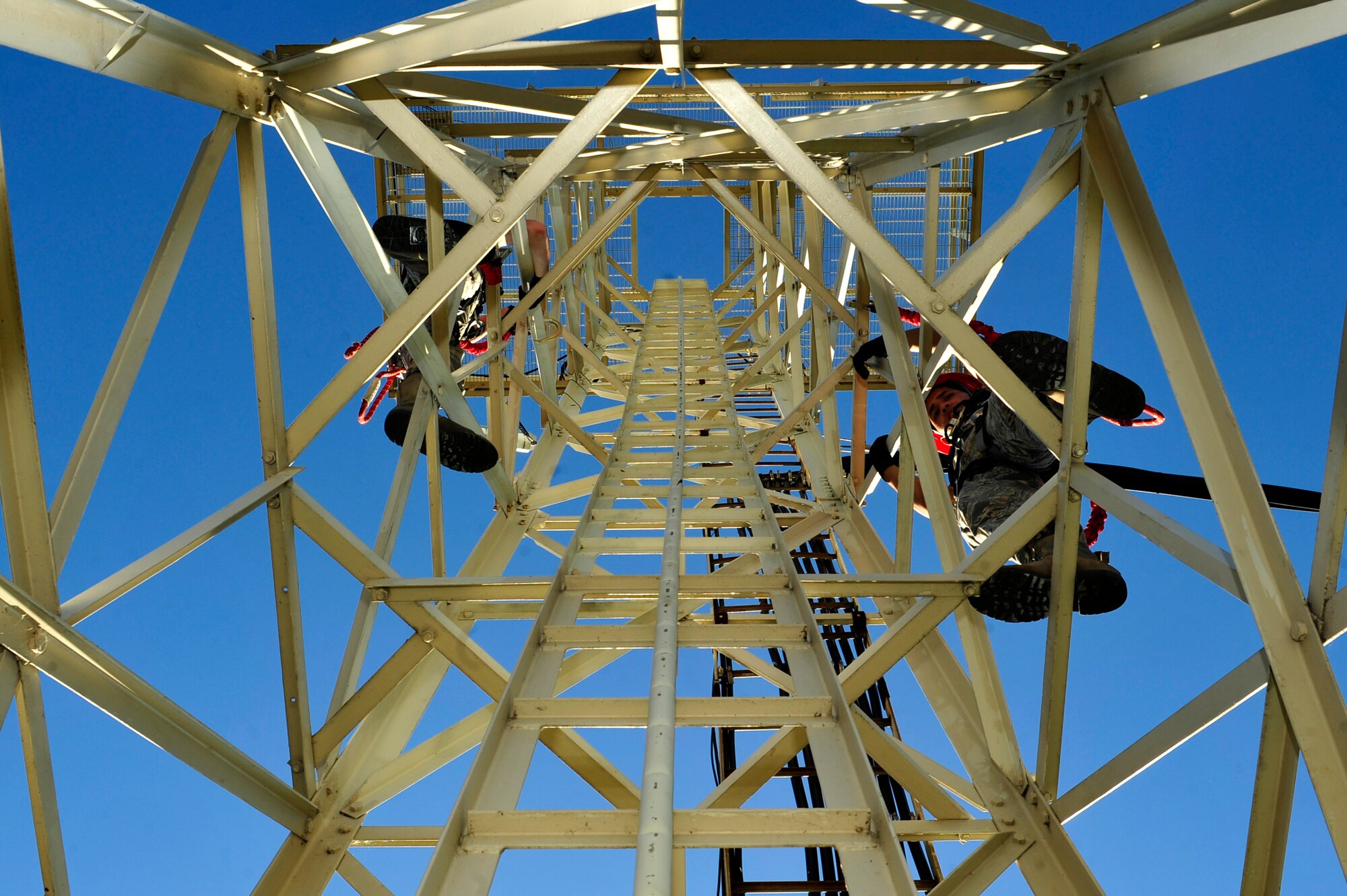 U.S. Air Force Airmen 1st Class Zackery Dwyer and Alexander Acosta, 633rd Communications Squadron cable and antenna maintainers, climbs a cable tower at Langley Air Force Base, Va., Nov. 3, 2015. Cables and antennas connected to the towers are vital for communication between personnel assigned to the 1st Operations Support Squadron and pilots. (U.S. Air Force photo by Senior Airman Breonna Veal/Released)