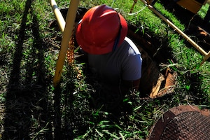U.S. Air Force Airman 1st Class Alexander Acosta, 633rd Communications Squadron cable and antenna maintainer, climbs down a manhole at Langley Air Force Base, Va., Nov. 3, 2015. Airmen from the cable and antenna maintenance section, known as the “Cable Dawgs,” install, maintain, reconstitute, remove and modify copper core, coaxial, waveguide and fiber optic cable and antenna systems. (U.S. Air Force photo by Senior Airman Breonna Veal/Released)