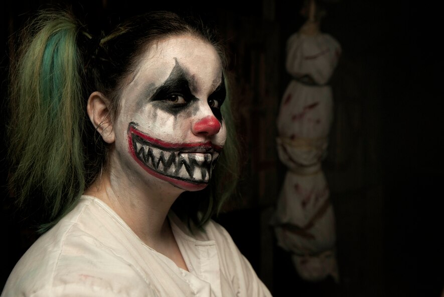 An actor dressed as a clown poses for a photo during the 13th annual haunted house exhibit in base housing on Bitburg Annex, Germany, Oct. 29, 2015. Actors took up to two hours to get in costume for the event. (U.S. Air Force photo by Staff Sgt. Christopher Ruano/Released)