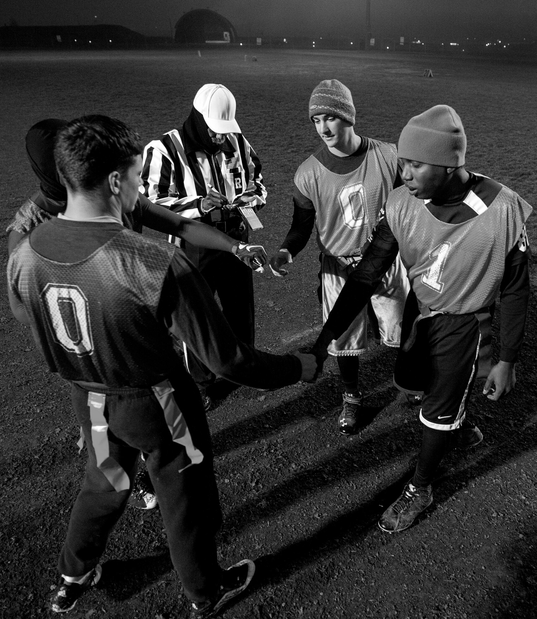 Team captains from the 52nd Civil Engineer Squadron and 52nd Communications Squadron Intramural Flag Football teams shake hands in the beginning of the 2015 Intramural Flag Football Championship game Nov. 3, 2015 at Spangdahlem Air Base, Germany. The 52nd CES scored first taking the lead 7-0 early in the first half. (U.S. Air Force photo by Senior Airman Rusty Frank/Released)