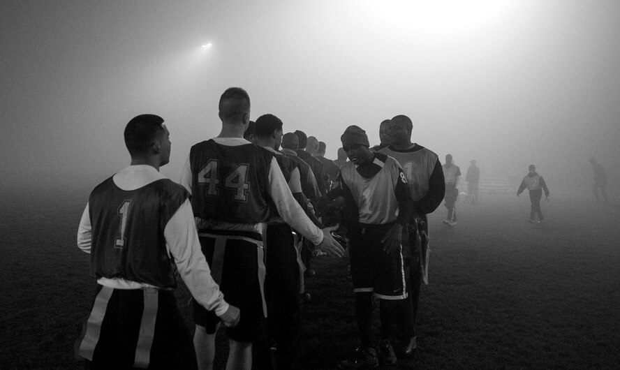 Members of the 52nd Civil Engineer Squadron and 52nd Communications Squadron Intramural Flag Football teams shake hands after the 2015 Intramural Flag Football Championship game Nov. 3, 2015 at Spangdahlem Air Base, Germany. The 52nd CS tied the game in the second half with a score of 13-13. (U.S. Air Force photo by Senior Airman Rusty Frank/Released)