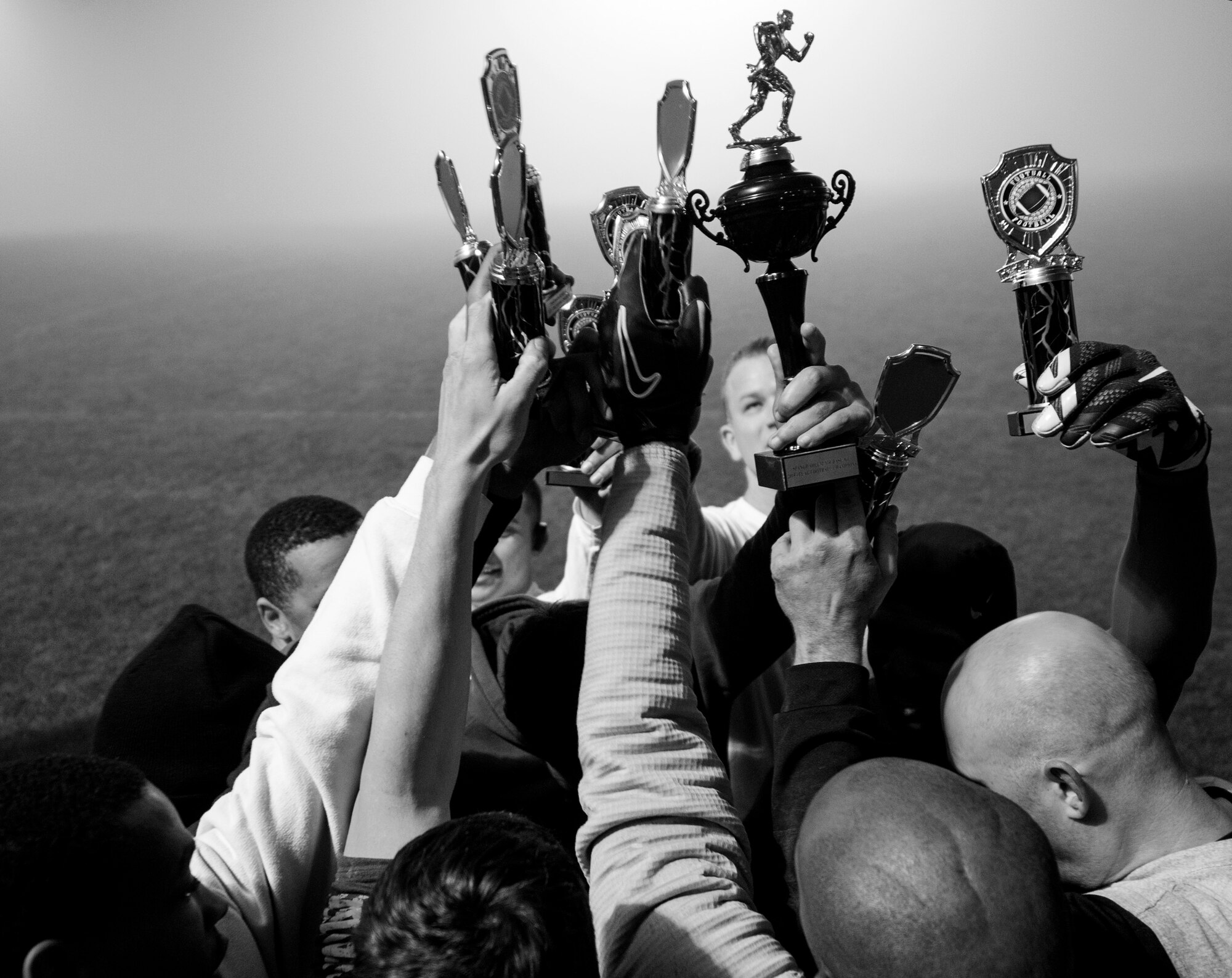 Members of the 52nd Civil Engineer Squadron Intramural Flag Football team hold up their trophies after the 2015 Intramural Flag Football Championship game Nov. 3, 2015 at Spangdahlem Air Base, Germany. The team won the game in overtime with a final score of 20-19. (U.S. Air Force photo by Senior Airman Rusty Frank/Released)