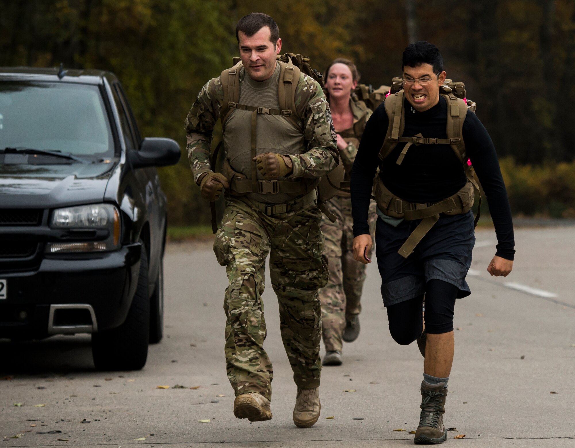 Explosive ordnance disposal ruck march participants sprint to the finish line Oct. 30, 2015, at Ramstein Air Base, Germany. During the ruck march, Airmen traversed three miles, climbed a six-foot wall and carried jerry cans for 50 meters all while wearing a 50-pound pack. The intent of the event was to help raise money for the 2015 Combined Federal Campaign-Overseas which  raises money for charitable organizations around the world that assist people and communities in need.  (U.S. Air Force photo/Senior Airman Jonathan Stefanko)
