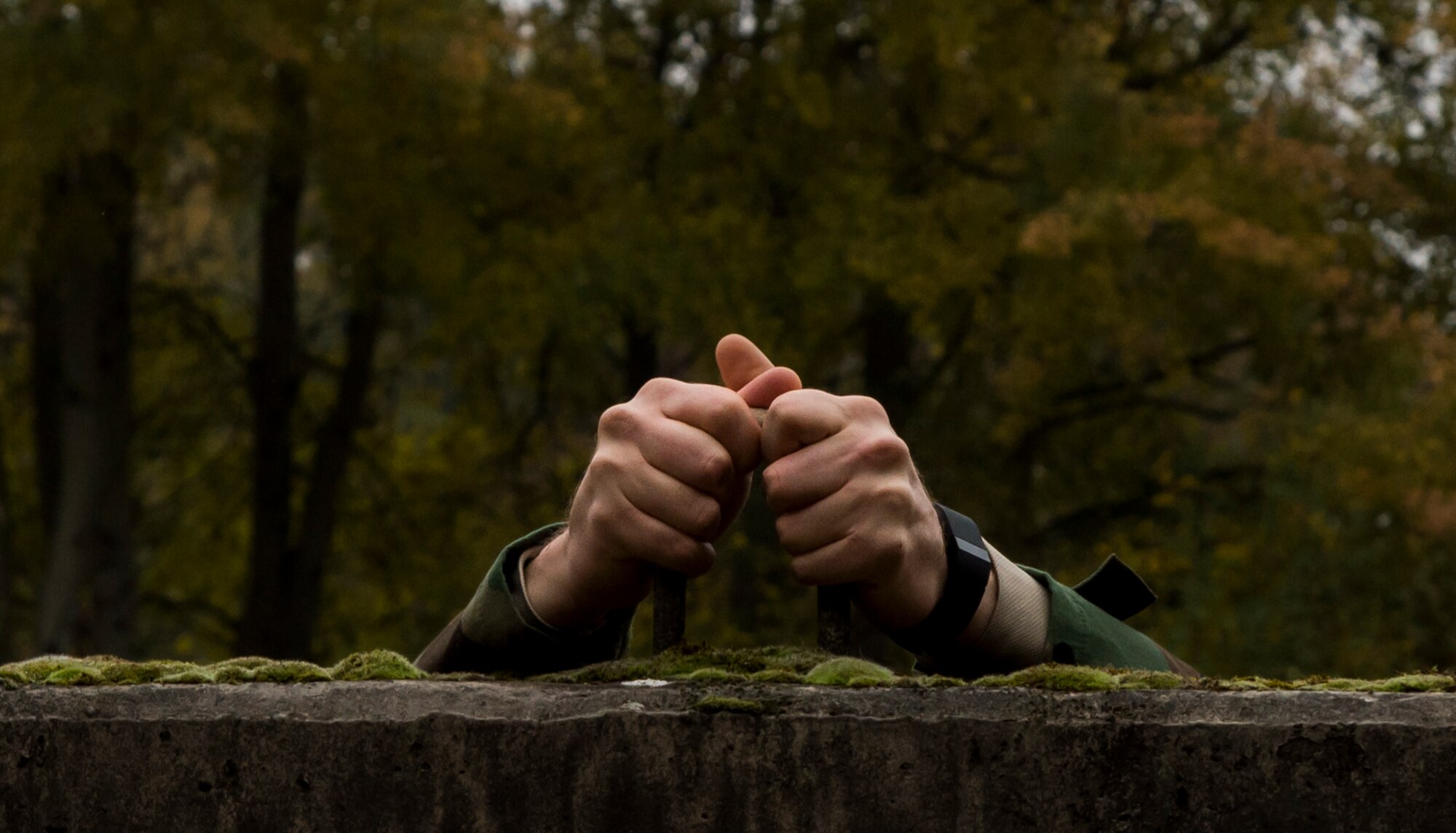 An explosive ordnance disposal ruck march participant begins his climb over a six-foot wall Oct. 30, 2015, at Ramstein Air Base, Germany. During the ruck march, Airmen traversed three miles, climbed a six-foot wall and carried jerry cans for 50 meters all while wearing a 50-pound pack with the intent of helping to raise money for the 2015 Combined Federal Campaign-Overseas. The mission of the CFC-O is to support and promote philanthropy through a voluntary program that is employee-focused, cost-efficient and effective in providing all federal employees the opportunity to improve the quality of life for all. (U.S. Air Force photo/Senior Airman Jonathan Stefanko)