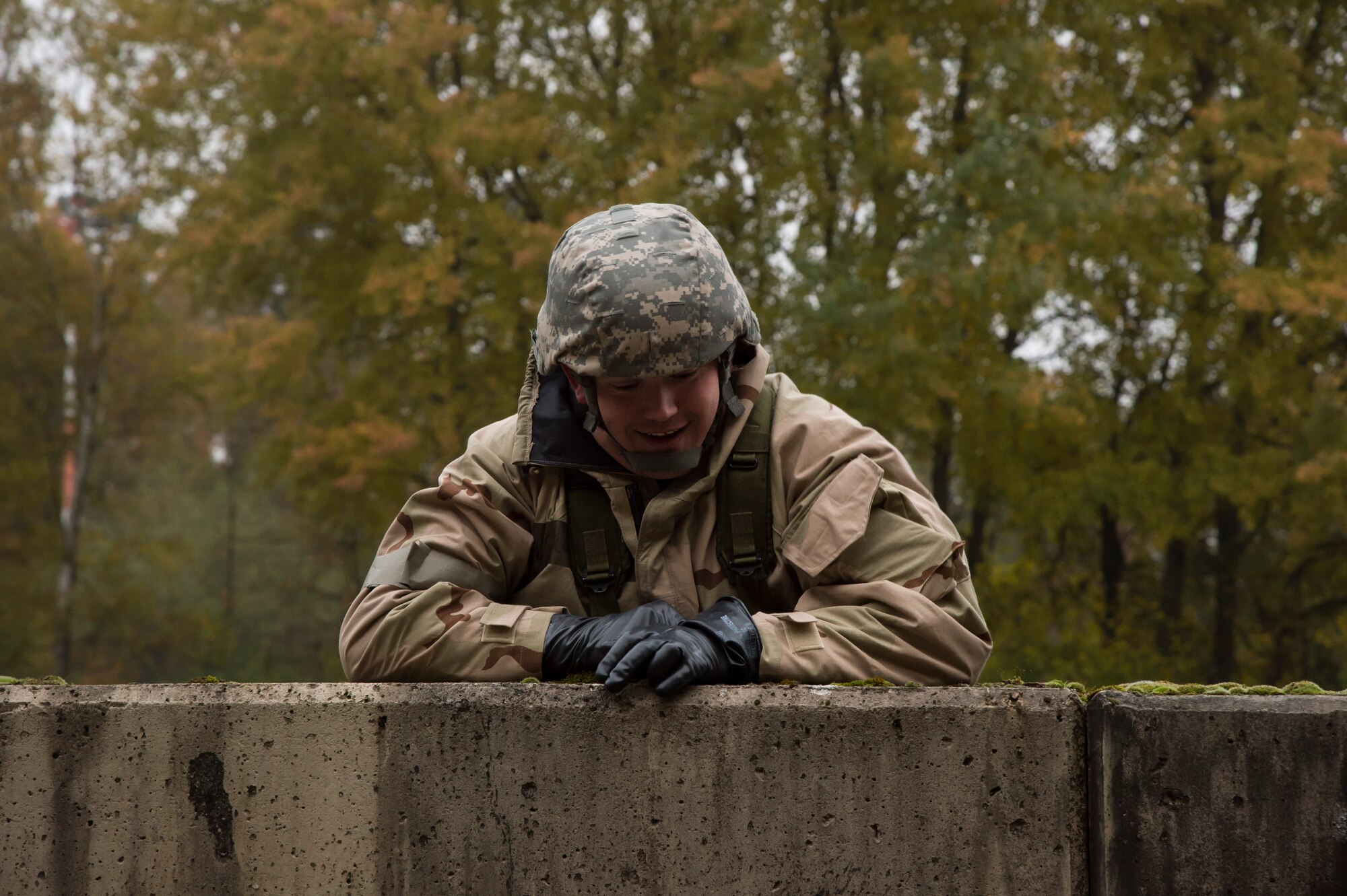 An explosive ordnance disposal ruck march participant climbs over a wall Oct. 30, 2015, at Ramstein Air Base, Germany. Participants traveled three miles, climbed a six-foot wall and carried jerry cans for 50 meters all while wearing a 50-pound pack as part of the event. The course was held to help raise money for the 2015 Combined Federal Campaign-Overseas. The mission of the CFC-O is to support and promote philanthropy through a voluntary program that is employee-focused, cost-efficient and effective in providing all federal employees the opportunity to improve the quality of life for all. (U.S. Air Force photo/Senior Airman Jonathan Stefanko)