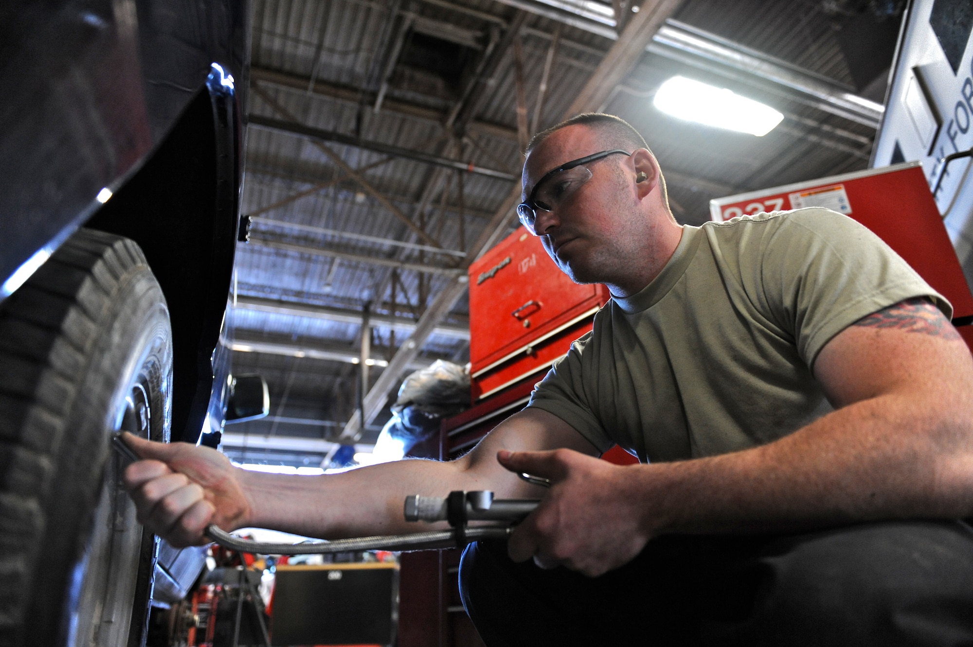 Senior Airman Jeremy Lee, 509th Logistics Readiness Squadron general purpose mechanic, checks the tire pressure on a government vehicle at Whiteman Air Force Base, Mo., Oct. 26, 2015. Routine checks and maintenance are performed to ensure readiness of the base’s government vehicles. (U.S. Air Force photo by Airman 1st Class Michaela R. Slanchik/Released)