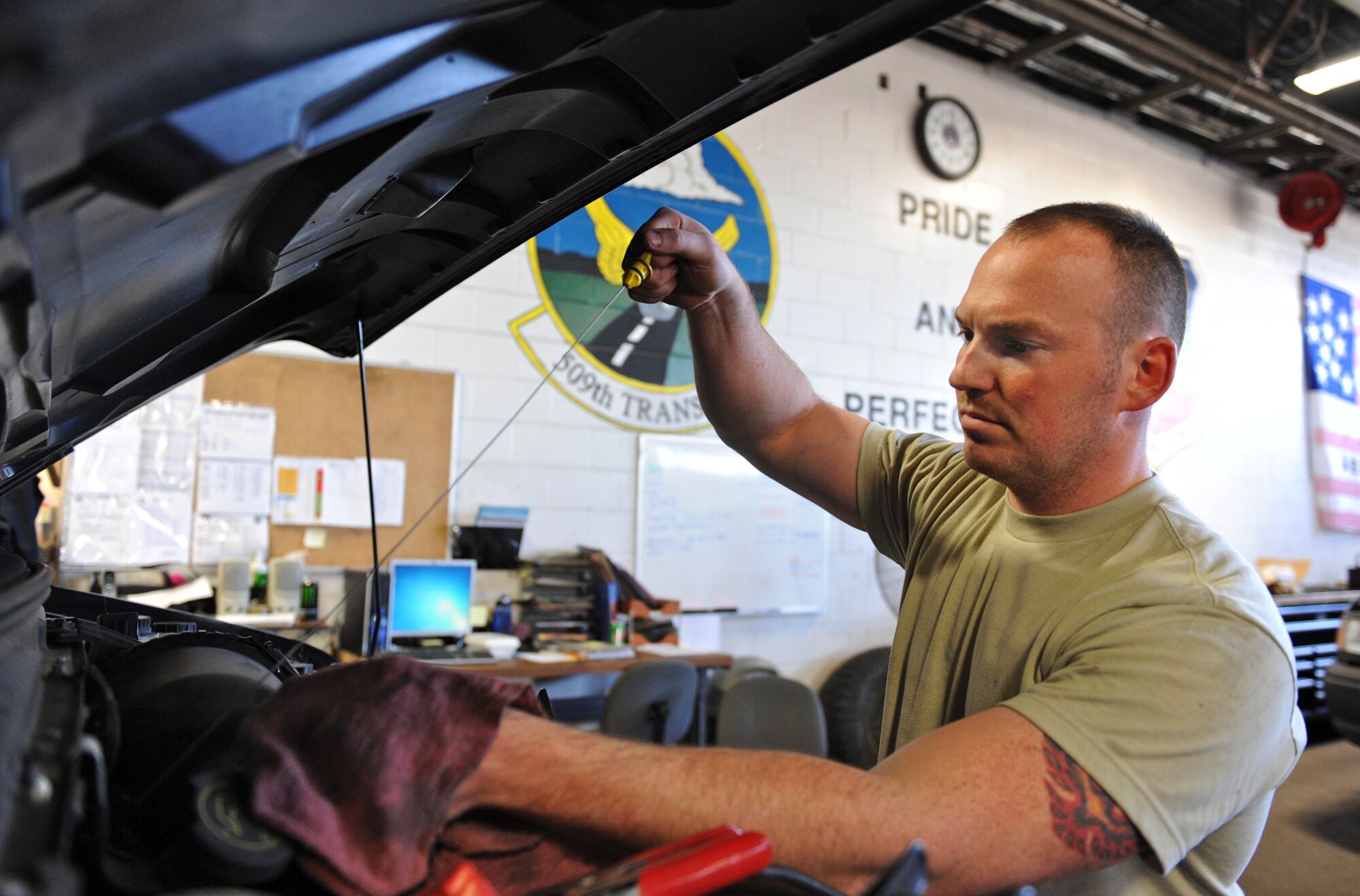 Senior Airman Jeremy Lee, 509th Logistics Readiness Squadron general purpose mechanic, checks the transmission fluid levels in a government vehicle at Whiteman Air Force Base, Mo., Oct. 26, 2015. Preventative maintenance such as checking fluid levels, tire pressure and tread are some of many duties vehicle maintainers perform to ensure the base’s fleet of vehicles is fully operational. (U.S. Air Force photo by Airman 1st Class Michaela R. Slanchik/Released)