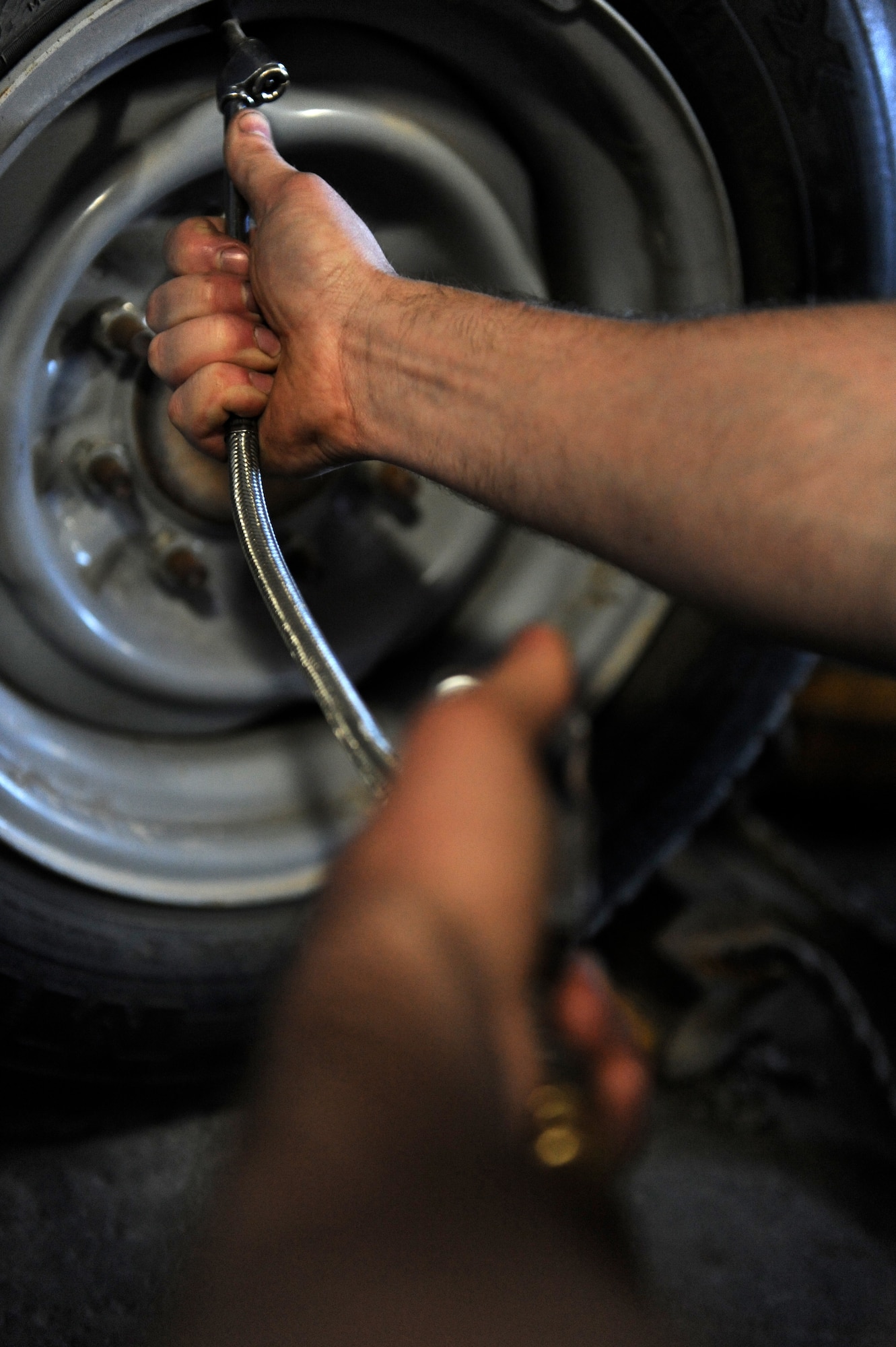 Senior Airman Jeremy Lee, 509th Logistics Readiness Squadron general purpose mechanic, checks the tire pressure on a government vehicle as part of routine maintenance at Whiteman Air Force Base, Mo., Oct. 26, 2015.  Vehicle maintainers perform daily maintenance, upholstery and body work on vehicles to ensure a fully operational fleet. (U.S. Air Force photo by Tech. Sgt. Miguel Lara III/Released)