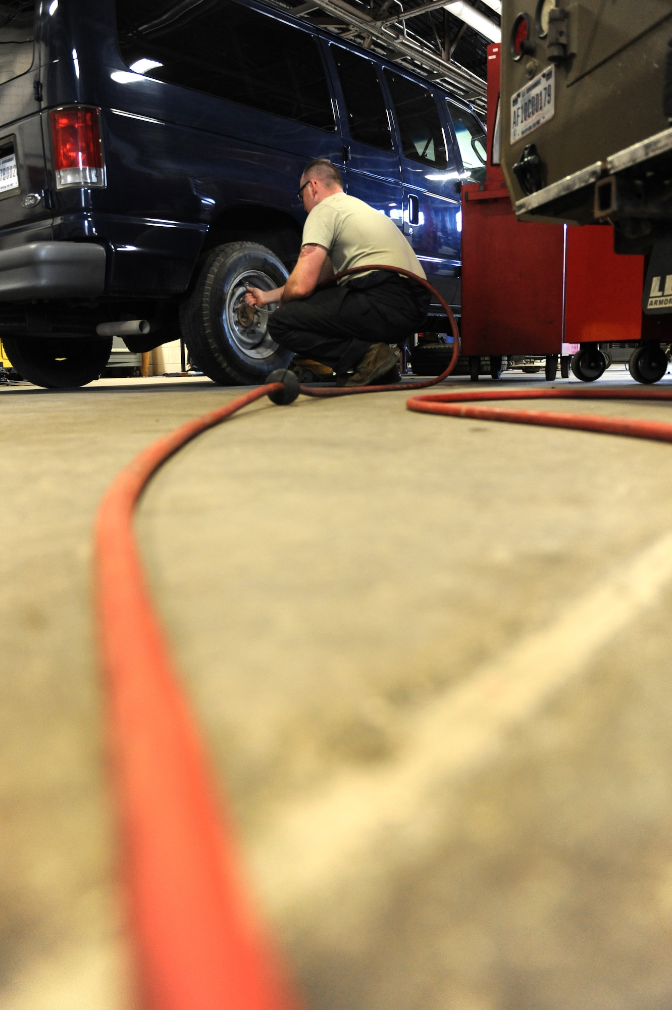 Senior Airman Jeremy Lee, 509th Logistics Readiness Squadron general purpose mechanic, checks the tire pressure on a government vehicle as routine maintenance at Whiteman Air Force Base, Mo., Oct. 26, 2015. Vehicle maintainers perform daily maintenance on vehicles to ensure they are fully operational. They also perform upholstery and body work on vehicles. (U.S. Air Force photo by Tech Sgt. Miguel Lara III/Released)