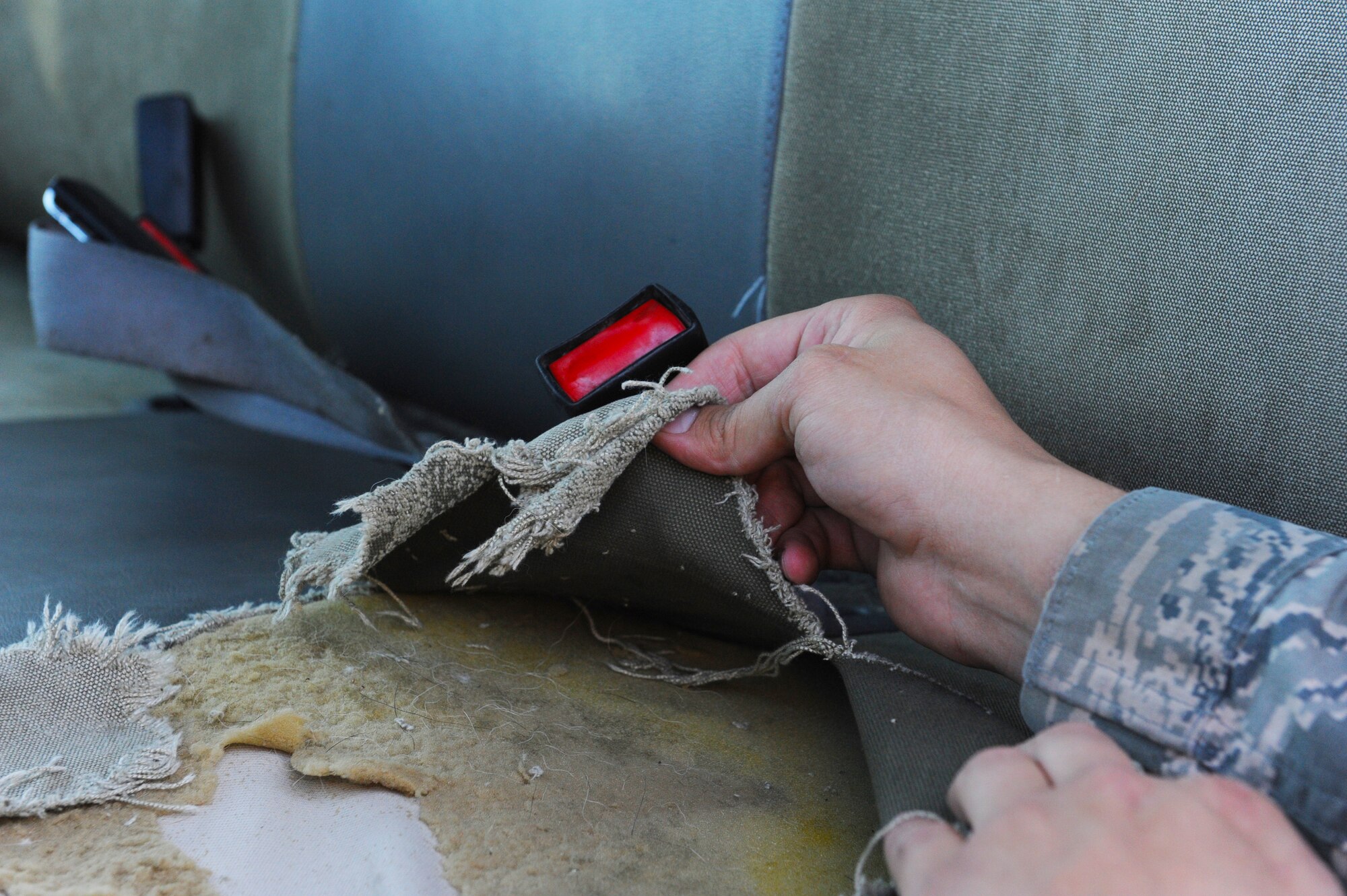 Staff Sgt. Christopher Miles, 509th Logistics Readiness Squadron (LRS) general purpose mechanic, inspects damaged upholstery on a government vehicle at Whiteman Air Force Base, Mo., Oct. 26, 2015.  The mission of the 509th LRS vehicle maintainers is to perform daily maintenance, body work and upholstery repairs to vehicles to ensure they are fully operational. (U.S. Air Force photo by Tech. Sgt. Miguel Lara III/Released)