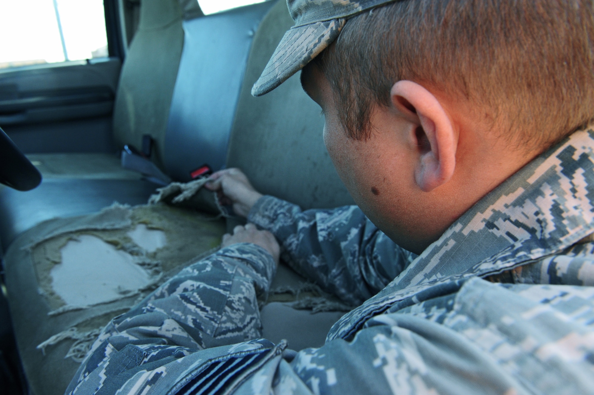 Staff Sgt. Christopher Miles, 509th Logistics Readiness Squadron (LRS) general purpose mechanic, inspects damaged upholstery on a government vehicle at Whiteman Air Force Base, Mo., Oct. 26, 2015.  The mission of the 509th LRS vehicle maintainers is to perform daily maintenance, body work and upholstery repairs to vehicles to ensure they are fully operational. (U.S. Air Force photo by Tech. Sgt. Miguel Lara III/Released)