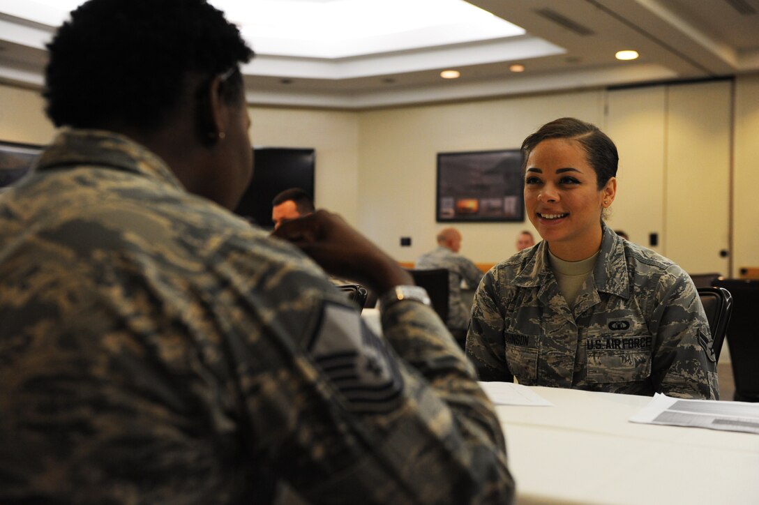 U.S. Air Force Airman 1st Class Chanel Johnson, 509th Operations Support Squadron air traffic controller, speaks to a senior NCO during a speed-mentoring event at Whiteman Air Force Base, Mo., Oct. 30, 2015.  The event consisted of a four hour block broken into two, two-hour sessions. Each session had 15 mentors available to discuss various Air Force matters. (U.S. Air Force photo by Tech. Sgt. Miguel Lara III/Released)