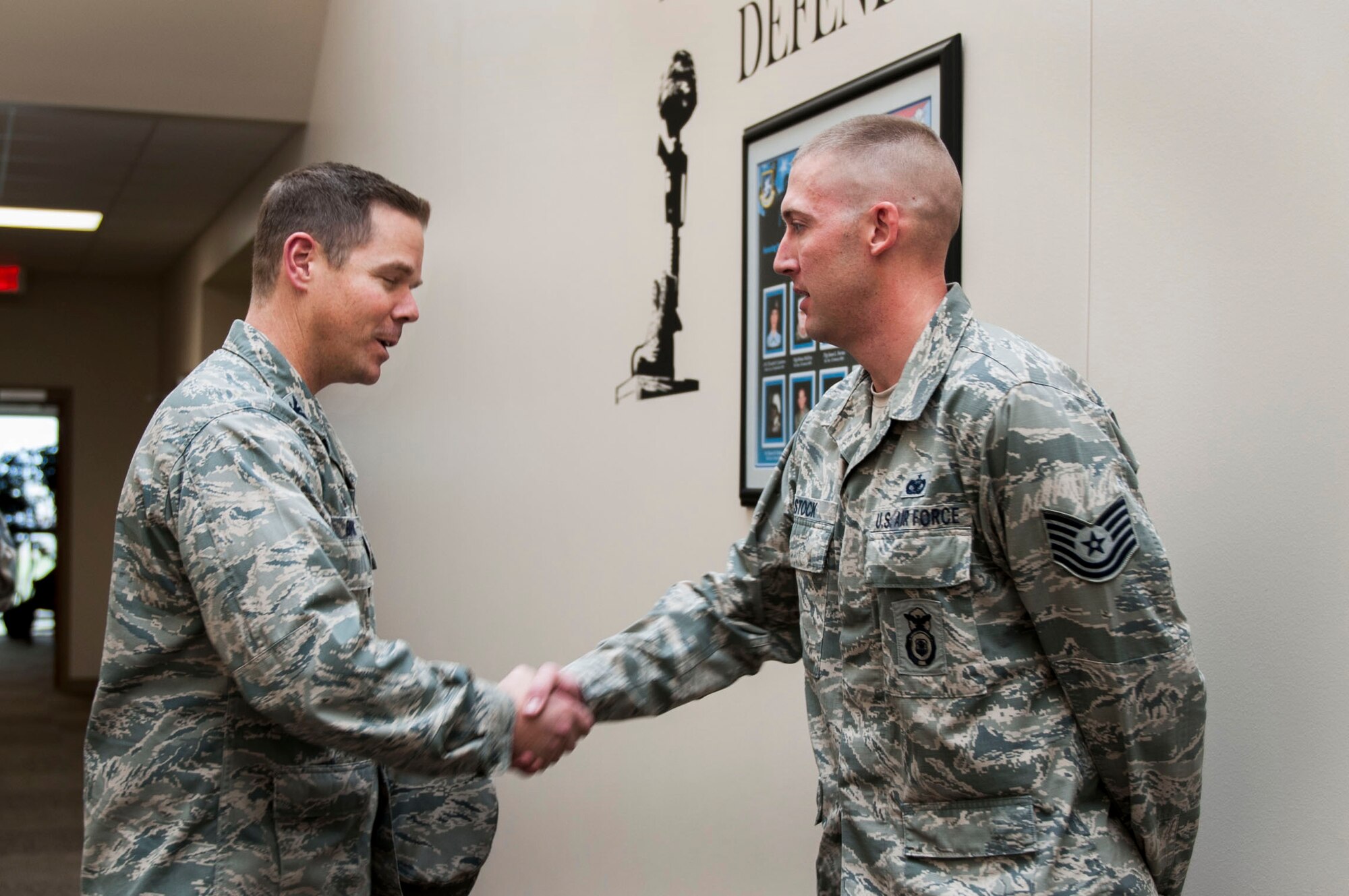 U.S. Air Force Col. Charles Brown Jr., 19th Airlift Wing commander, congratulates U.S. Air Force Tech. Sgt. Adam Stock, 19th Security Forces Squadron unit resource advisor, as Combat Airlifter of the Week Nov. 2, 2015, on Little Rock Air Force Base, Ark. Stock handles the unit’s $200,000 budget, Government Travel Card and Government Purchase Card programs and Defense Travel System orders. (U.S. Air Force photo by Senior Airman Stephanie Serrano)