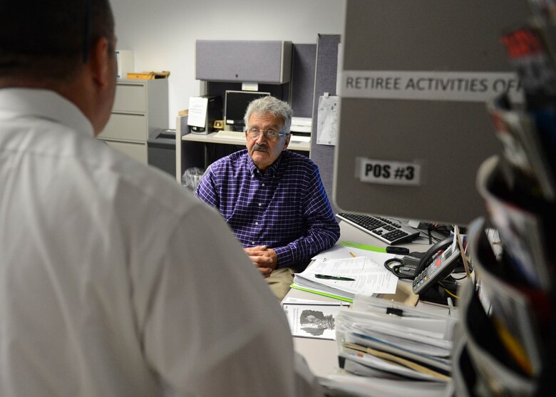 Jim Kelleher, a retired U.S. Army staff sergeant, speaks with a recently retired service member while working as the duty officer in the Retiree Activities Office last month. The Retiree Activities Office at Hanscom provides information, services and programs to retired military veterans of all ranks and services. (U.S. Air Force photo by Jerry Saslav)
