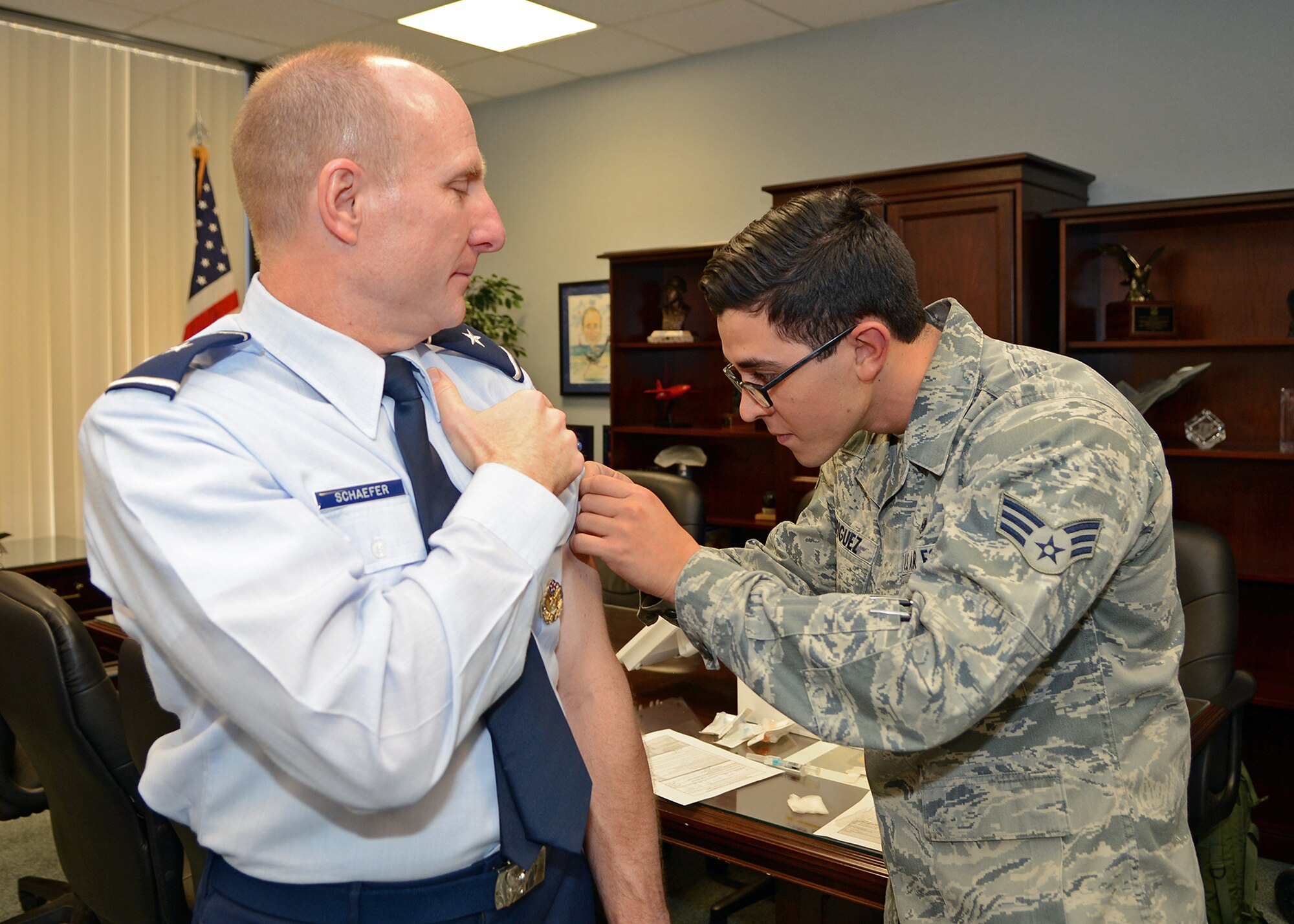 Brig. Gen. Carl Schaefer, 412th Test Wing commander, receives his annual flu shot from Senior Airman Jeffrey Rodriguez, 412th Medical Operations Squadron. It's that time of year for all Airmen to receive their flu shot. Tricare beneficiaries can come to the Immunizations Clinic beginning Nov. 6 to receive their flu shot. (U.S. Air Force photo by Jet Fabara)