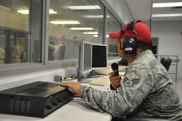 Senior Airman Luis Lira III, 88th Security Forces Squadron CATM instructor, gives instructions to M9 qualification course students from the range control tower. (U.S. Air Force photo/Bryan Ripple.)