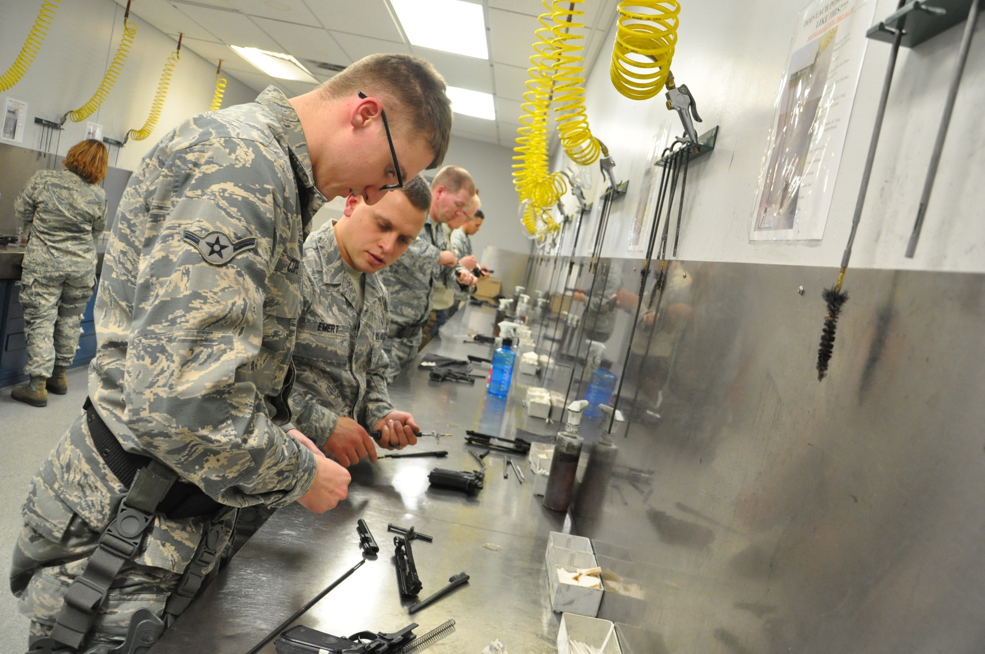 Airman Chris Cope, a Health Service Management apprentice from the 88th Medical Group, works on cleaning his M9 Beretta after completing the M9 qualification course. Students are taught by CATM instructors how to properly disassemble their weapon, clean it properly and reassemble it to proper working condition for the next student’s use. (U.S. Air Force photo/Bryan Ripple.)