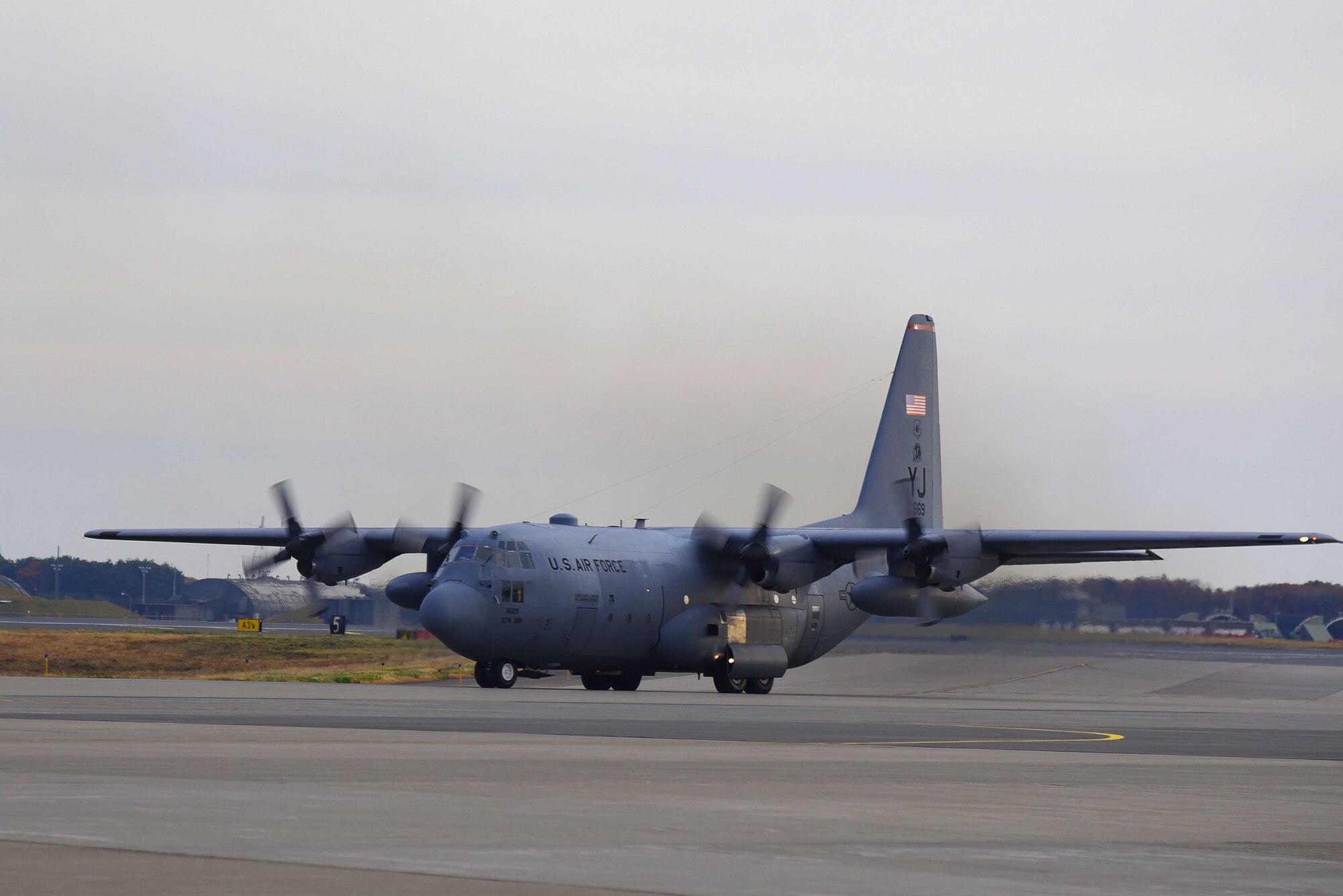 A C-130 Hercules aircraft from Yokota Air Base, Japan, taxis down the runway in the early morning at Misawa Air Base, Japan, Nov. 2, 2015. Yokota provided several C-130 aircraft in support of exercise Vigilant Ace 16, where it transported more than 600 personnel over the course of three days to Osan Air Base, Korea. (U.S. Air Force photo by Senior Airman Patrick S. Ciccarone/Released)